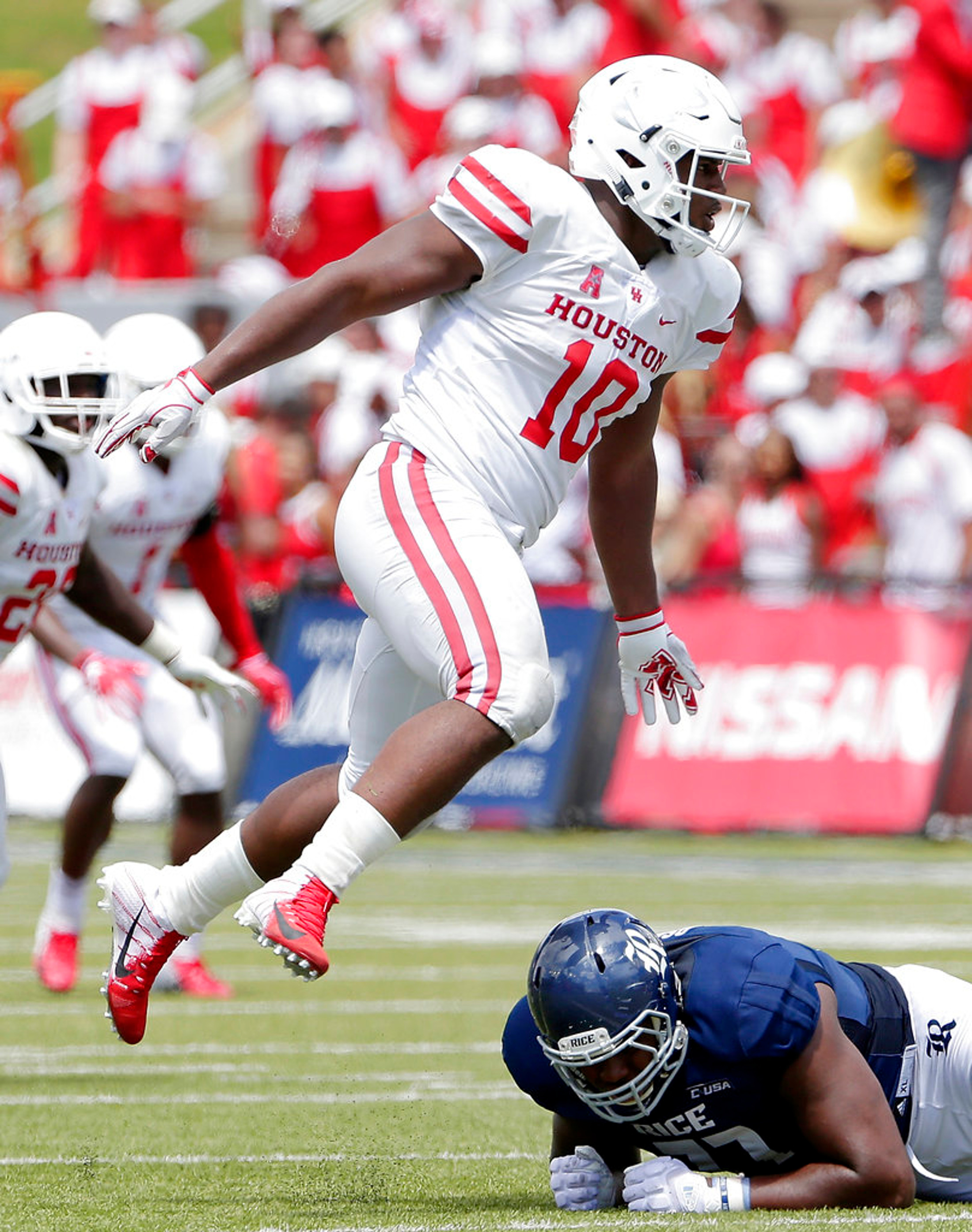 FILE - In this Sept. 1, 2018, file photo, Houston defensive tackle Ed Oliver (10) jumps over Rice offensive lineman Uzoma Osuji during a NCAA college football game, in Houston. (AP Photo/Michael Wyke, File)