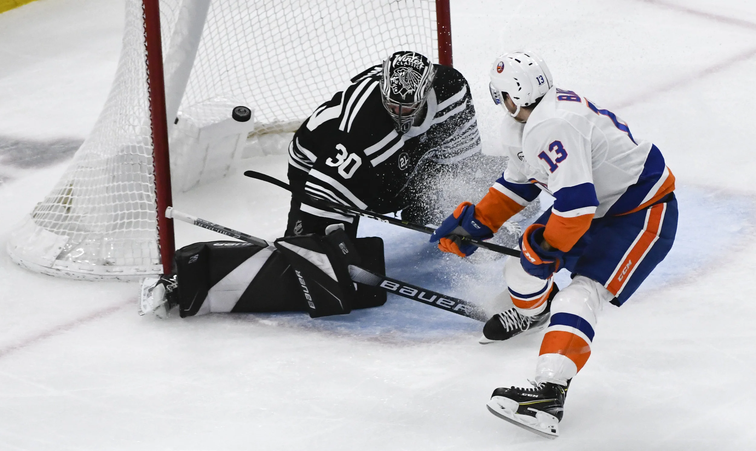 New York Islanders center Mathew Barzal (13) scores a gaol past Chicago Blackhawks goaltender Cam Ward (30) during the second period of an NHL hockey game on Tuesday Jan. 22, 2019, in Chicago. (AP Photo/Matt Marton)