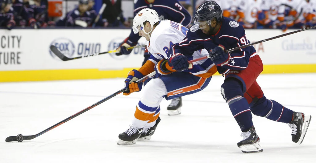 Columbus Blue Jackets' Anthony Duclair, right, tries to stop New York Islanders' Scott Mayfield from shooting during the third period of an NHL hockey game Thursday, Feb. 14, 2019, in Columbus, Ohio. (AP Photo/Jay LaPrete)