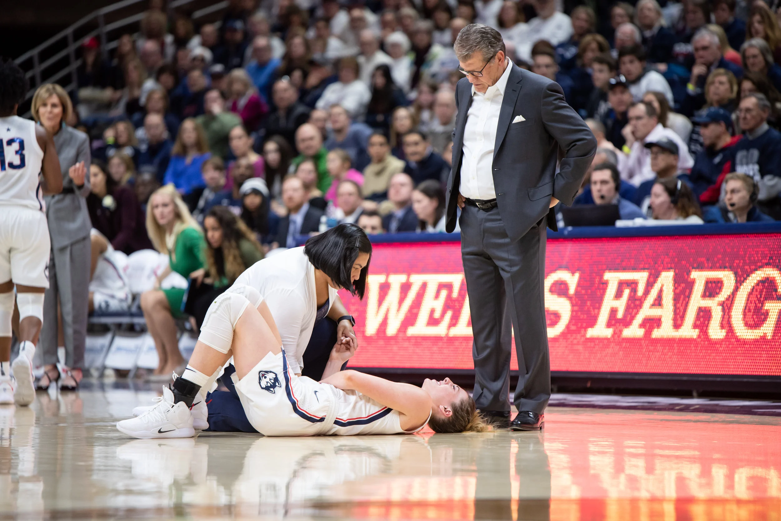 Senior Katie Lou Samuelson went down in pain after diving for a loose ball. The team is confident she will be back shortly. (Charlotte Lao/The Daily Campus)