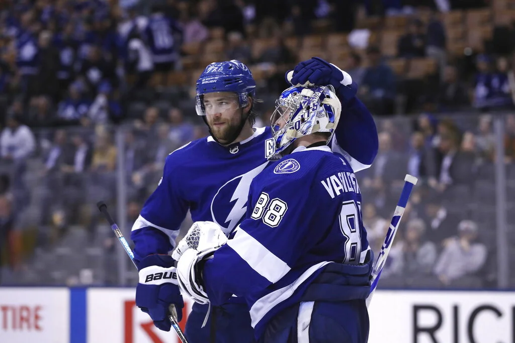 Tampa Bay Lightning defenseman Victor Hedman (77) celebrates with goaltender Andrei Vasilevskiy (88) after their victory over the Toronto Maple Leafs in NHL hockey game action in Toronto on Monday, March 11, 2019. (Cole Burston/The Canadian Press via AP)