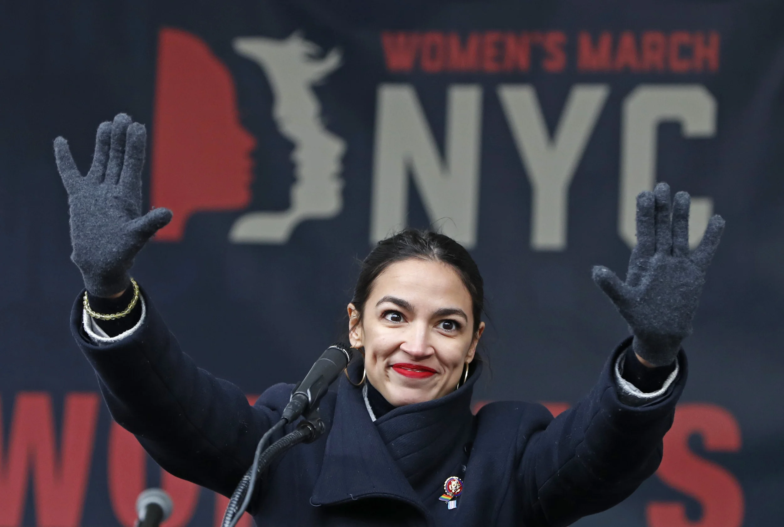 In this Jan. 19, 2019, file photo, U.S. Rep. Alexandria Ocasio-Cortez, (D-New York) waves to the crowd after speaking at Women's Unity Rally in Lower Manhattan in New York. To Democratic supporters, the Green New Deal is a touchstone, a call to arms to combat climate change. To Republican opponents, it’s zealous environmentalism, a roadmap to national bankruptcy. Lost in the clamor is the reality that, if passed, the much-hyped Green New Deal would require the government to do absolutely nothing. (AP Photo/Kathy Willens, File)