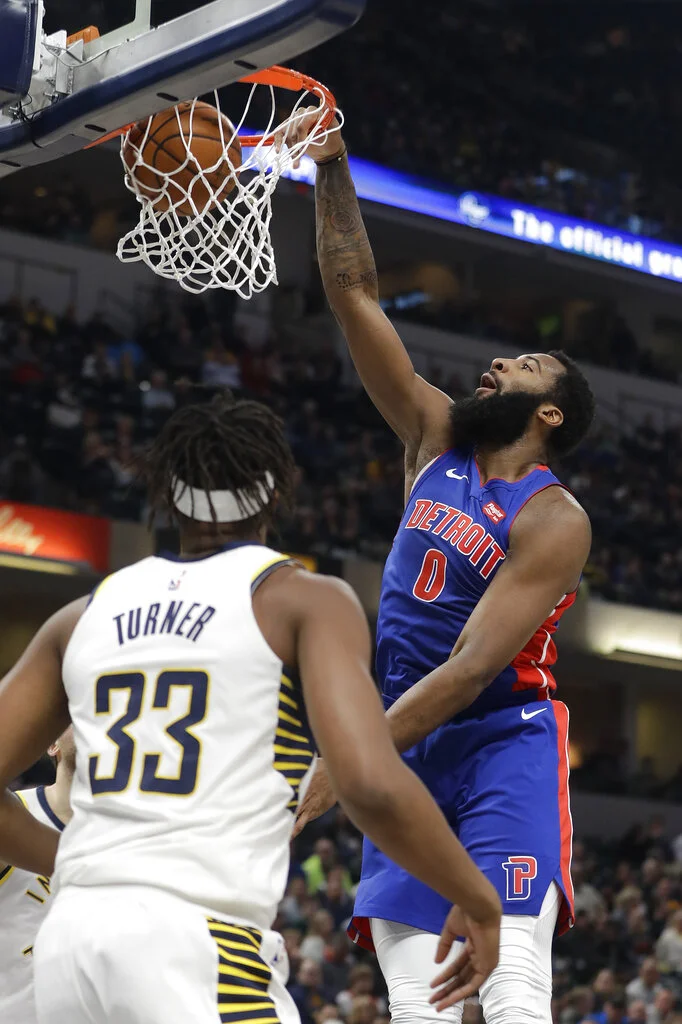 Detroit Pistons' Andre Drummond (0) dunks against Indiana Pacers' Myles Turner (33) during the first half of an NBA basketball game, Monday, April 1, 2019, in Indianapolis. (AP Photo/Darron Cummings)