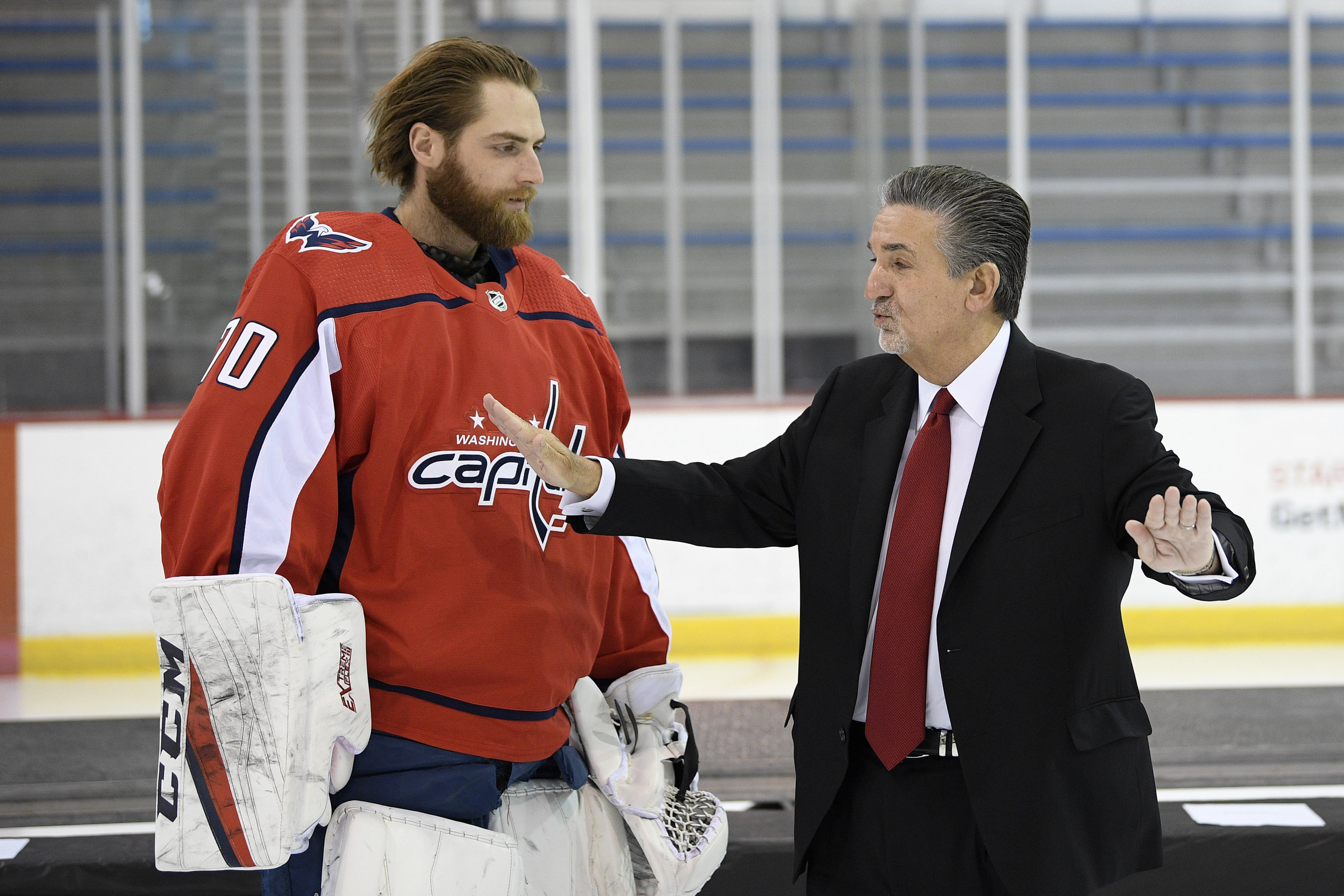 Washington Capitals team owner Ted Leonis, right, talks with goaltender Braden Holtby, left, at an NHL hockey team picture session, Wednesday, April 3, 2019, in Arlington, Va. (AP Photo/Nick Wass)
