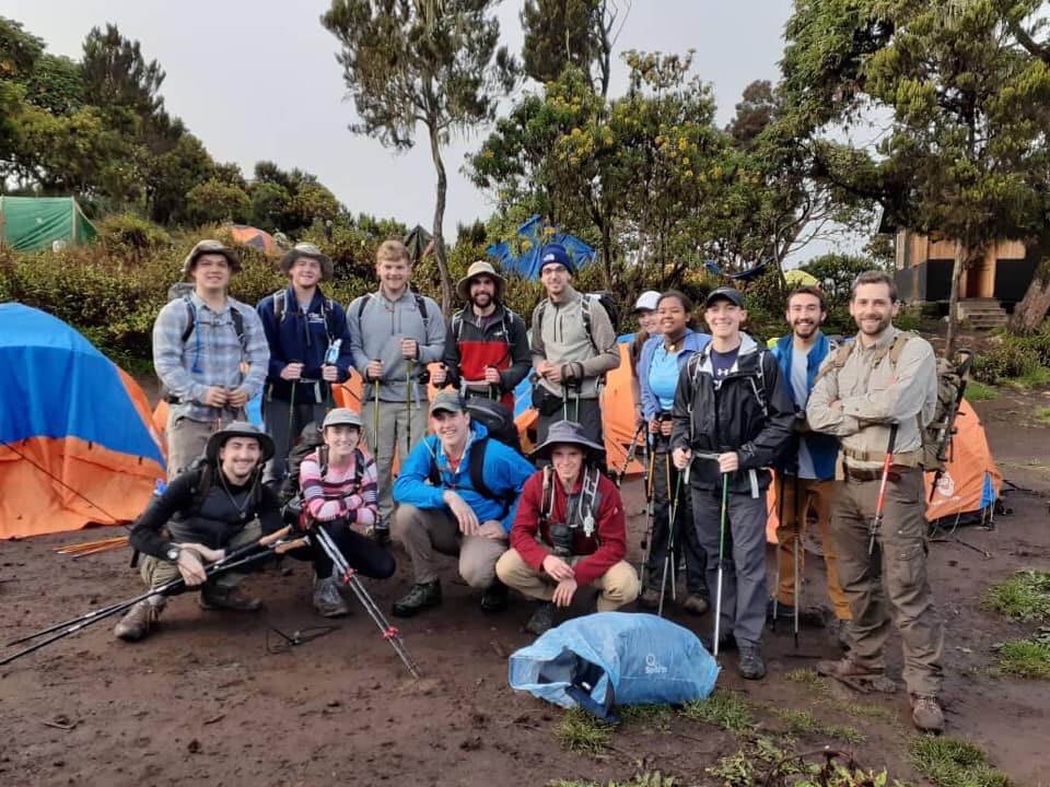 Photo by Rita Plante, Group shot at a campsite during the 2019 Kilimanjaro Trek