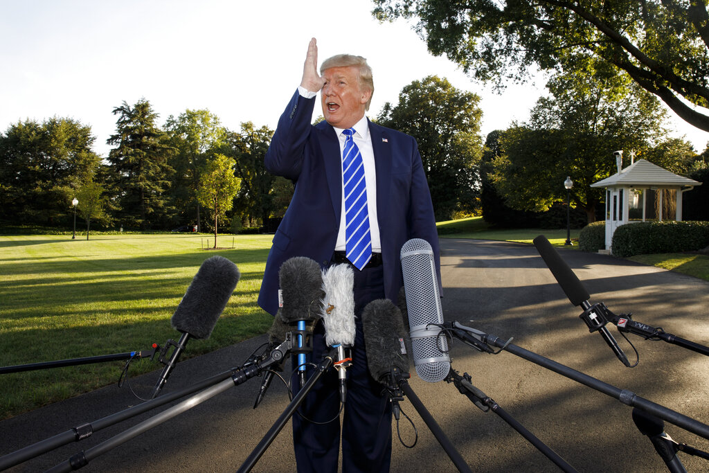 President Donald Trump talks to media before boarding Maine One at the White House in Washington, Friday, Aug. 30, en route to Camp David in Maryland. Photo by Carolyn Kaster/Associated Press