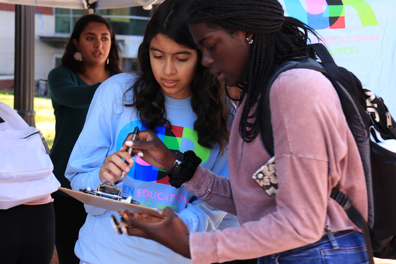 Members of PIRG hand out T-shirts on Fairfield way. Students who passed by their table were asked to complete a survey about how much they paid for textbooks this year.  Photo by Erin Knapp/The Daily Campus