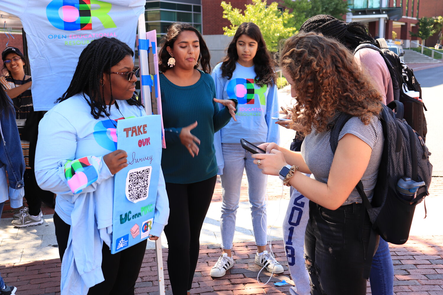 An example of UConnPIRG’s work around campus: Members of PIRG hand out T-shirts on Fairfield way. Students who passed by their table were asked to complete a survey about how much they paid for textbooks this year.  Photo by Erin Knapp / The Daily Campus.