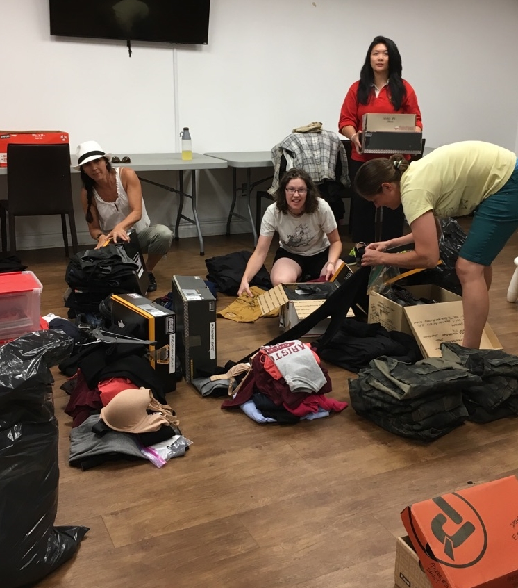 SUMMER 2016 - ABOVE - Some of our volunteers sorting through the generous donation from CCI Entertainment