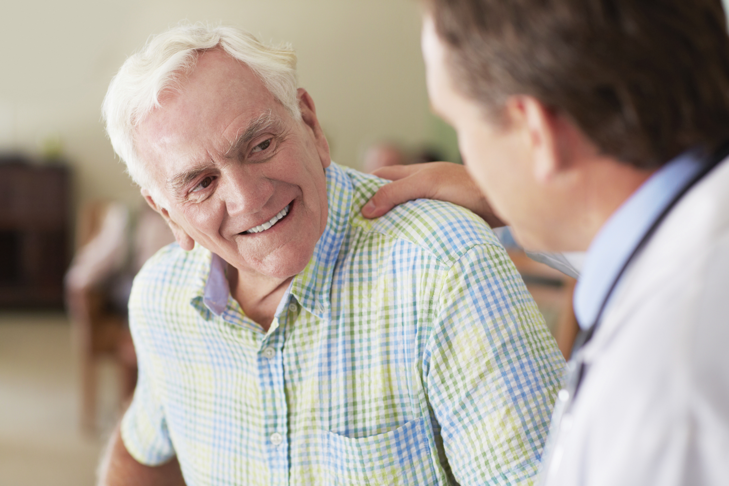 Doctor with hand on patient's shoulder.