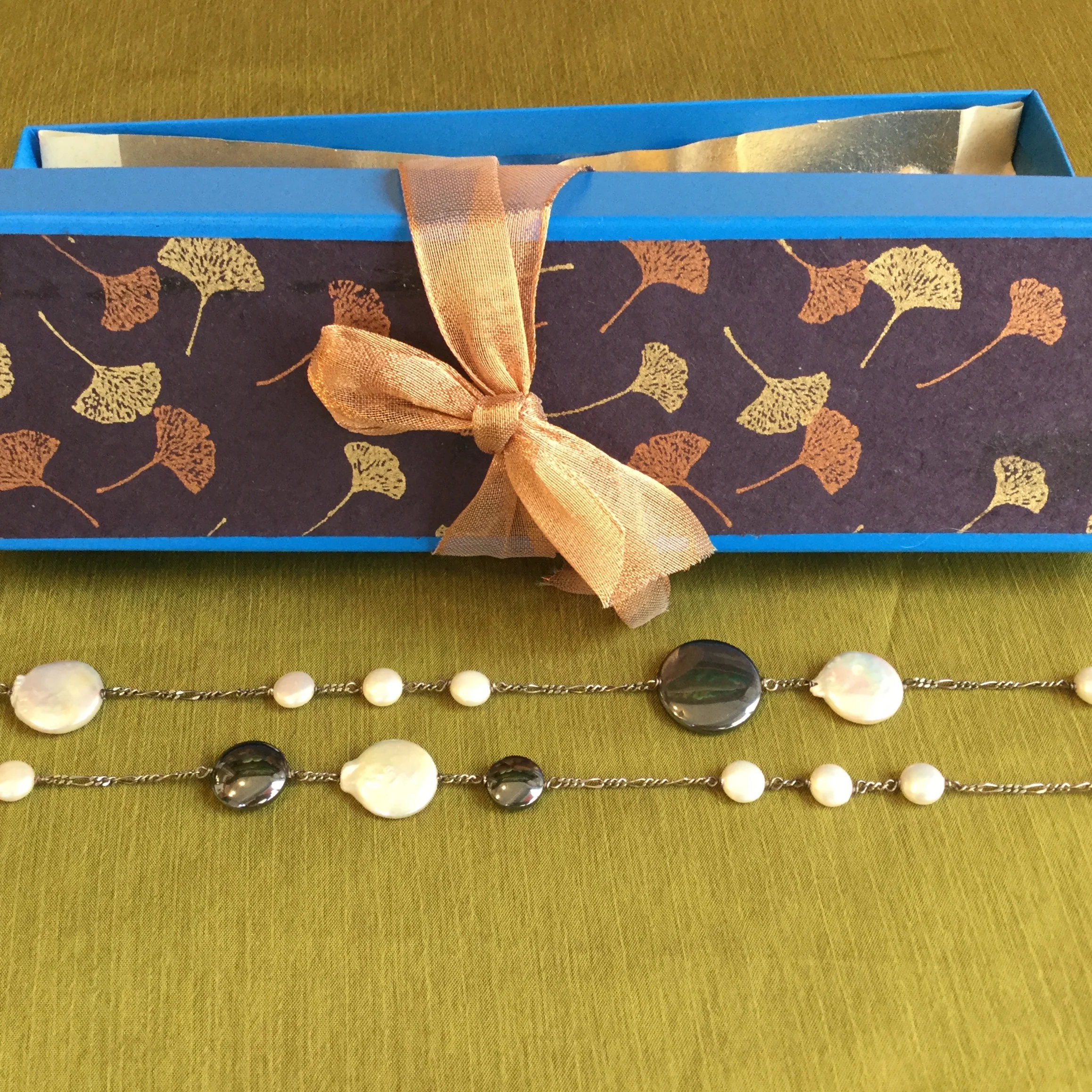 Auction Item 08: Necklace - Silver chain hematite and coin pearl 40". Value: $150.-- Jeweler: Teresa Montalvo.