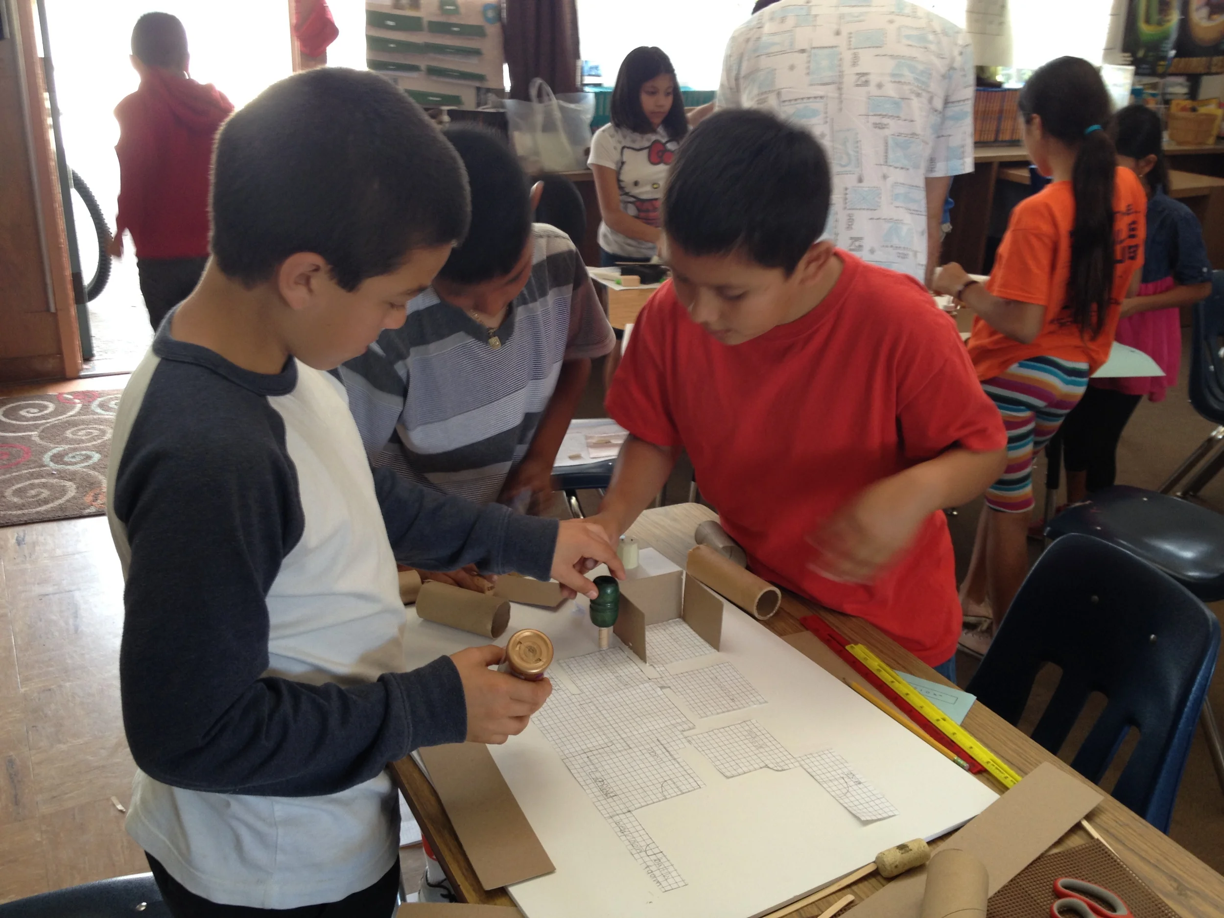 STUDENTS BUILDING THEIR MODEL FROM A FLOOR PLAN. 