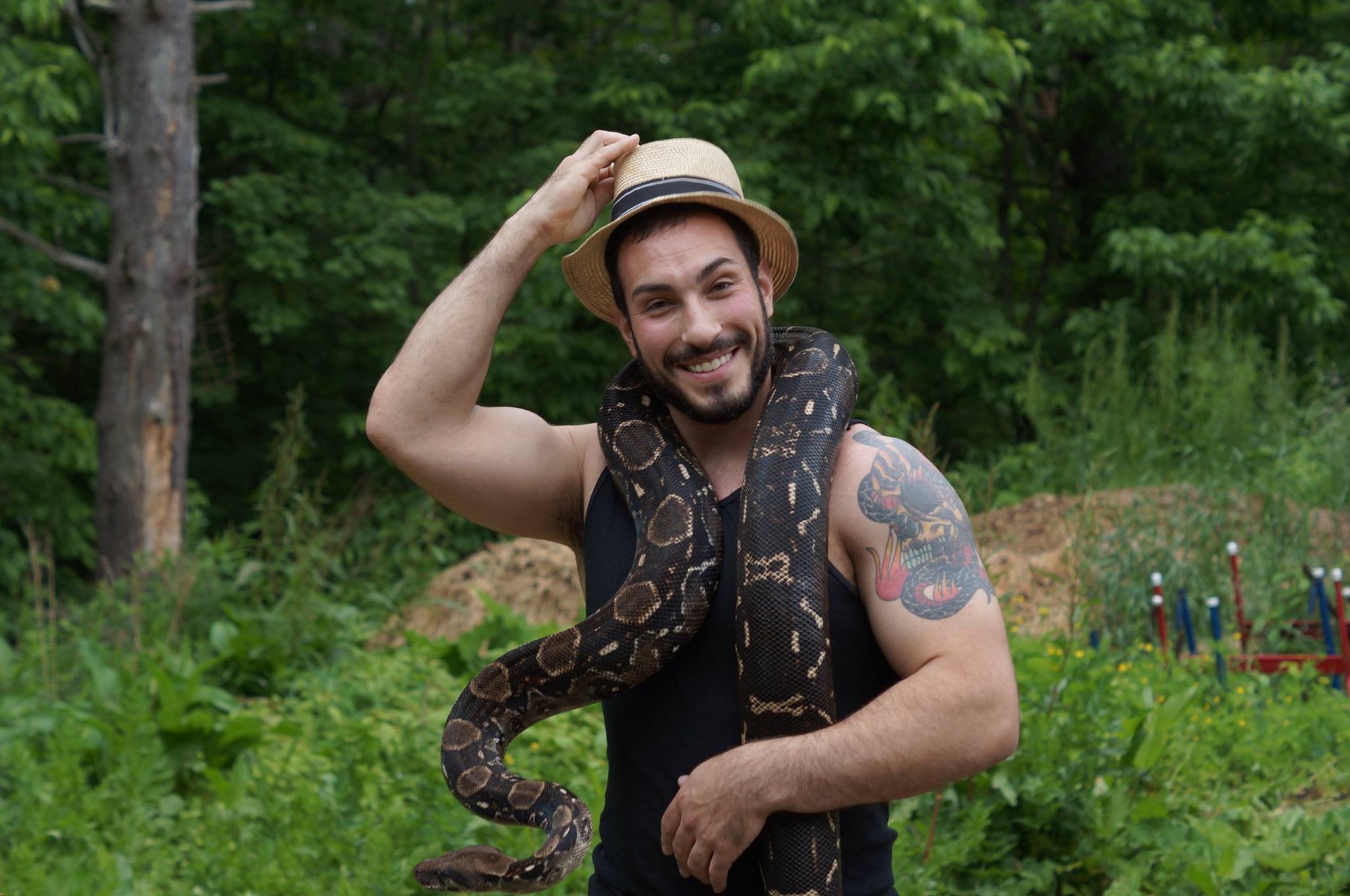 Jason Raimondi steps off set with one of his snakes.