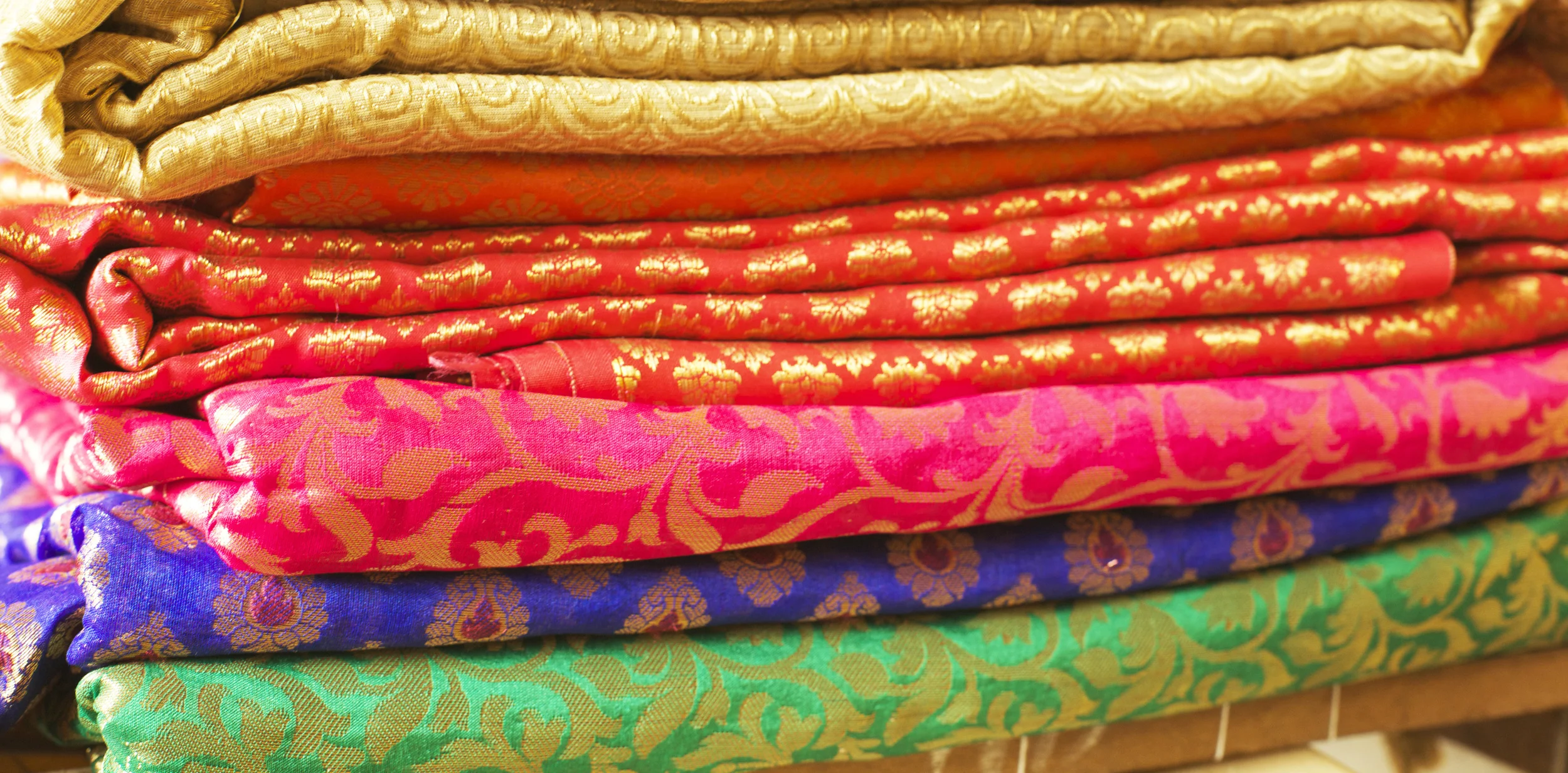 Upon entering one of the local textile shops, our focus was to find pieces similar to the vintage saris Reshma's grandmother generously donated in an effort to support our cause. Luckily, we stumbled across some of the most vibrant colored, uniquely patterned pieces of fabric!