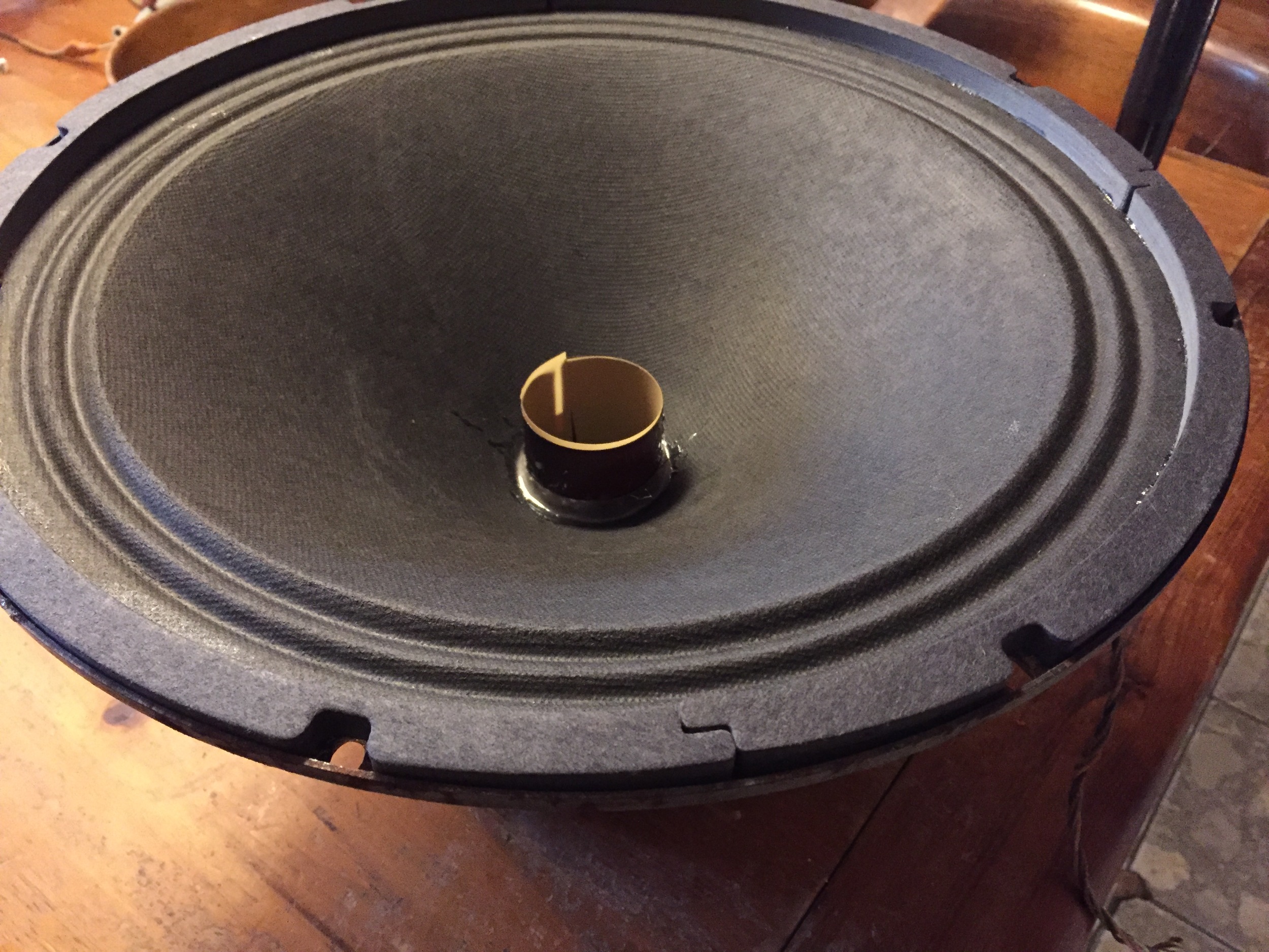 Cone cemented in place, over new voice coil and spider. New gasket material, temporary spacer.