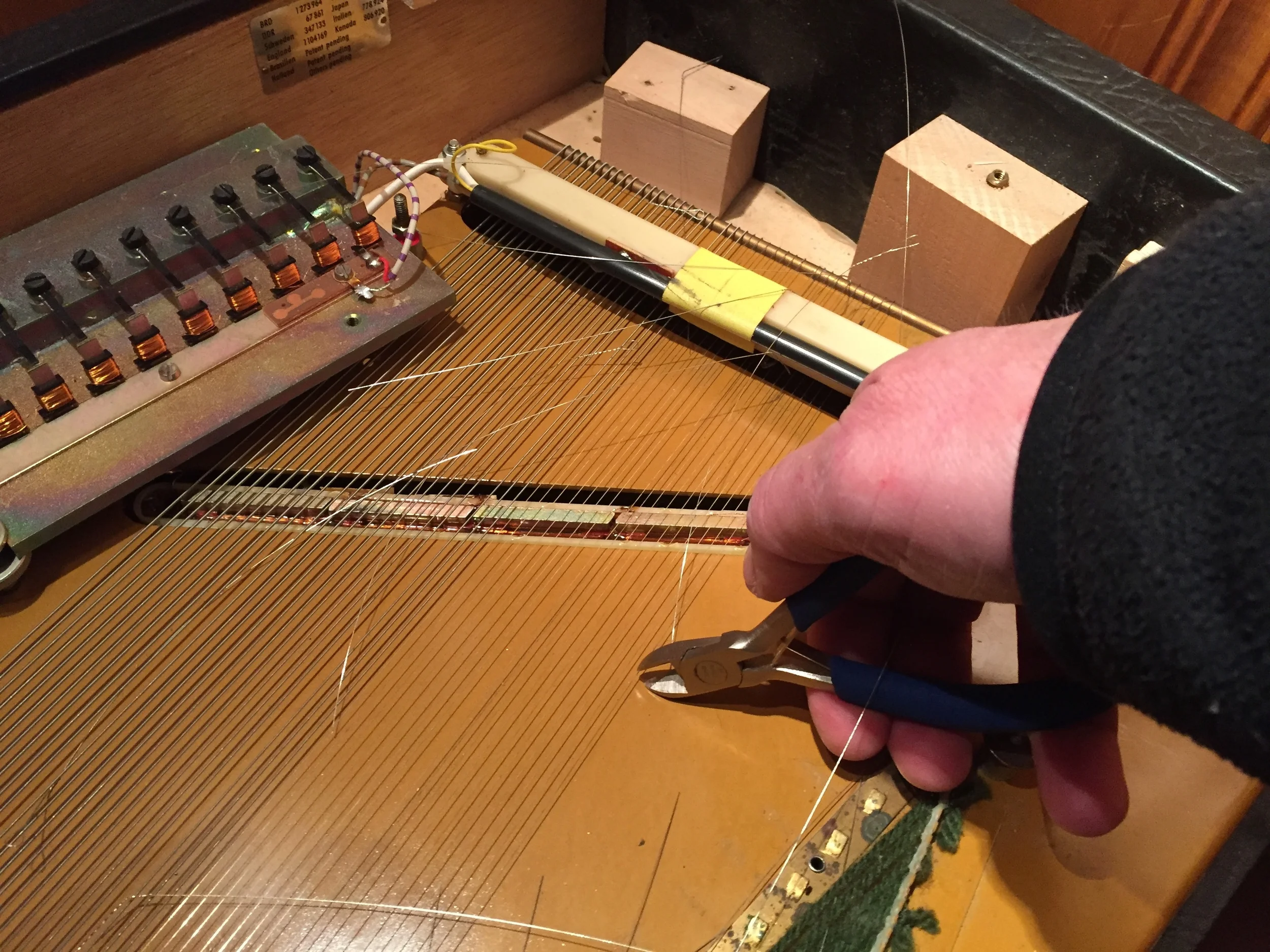 Cutting away the old strings.
