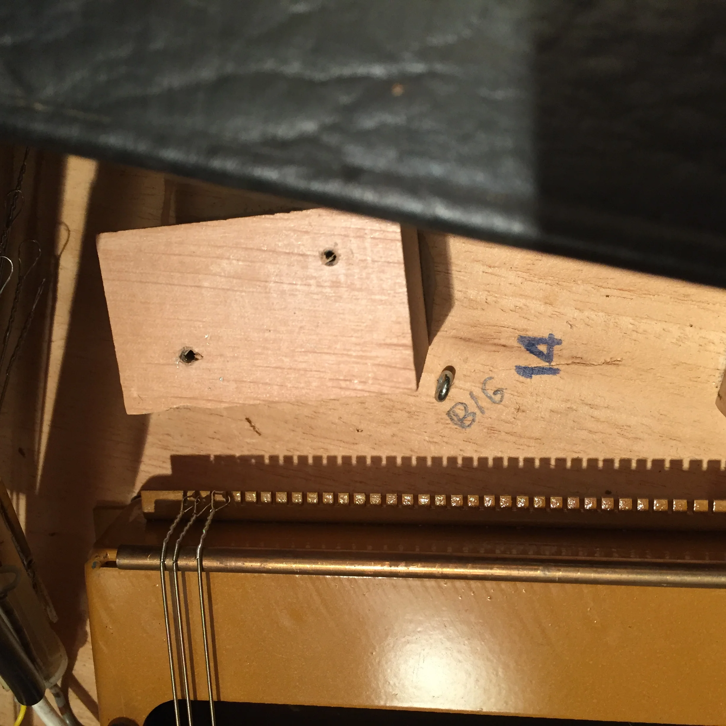The bridge end of the new strings.