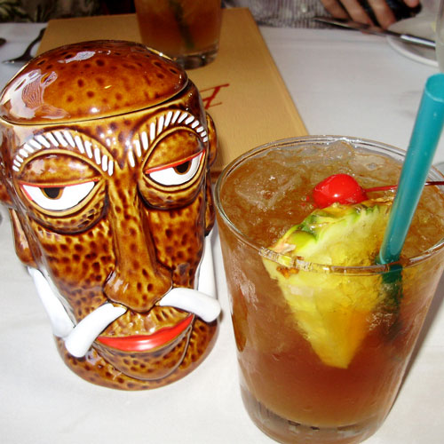 The famous Mr. Goof tiki mug next to a Mai Tai at Bali Hai