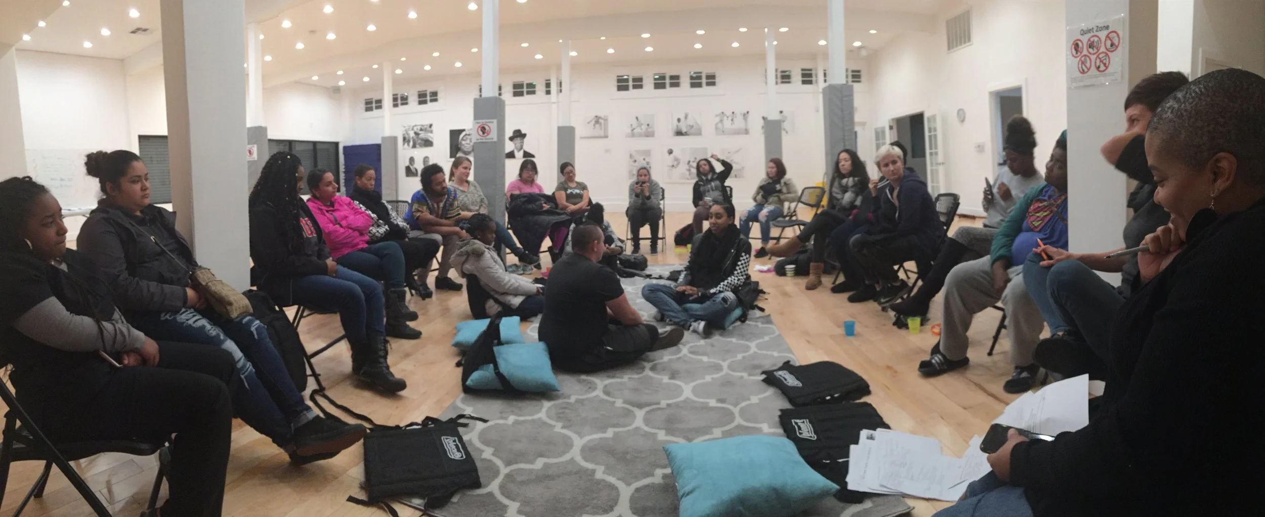 Pictured: Trainees (Katie and Maile) at the center of the fish bowl as they volunteered to demonstrate examples of possible situations they may encounter at a birth.