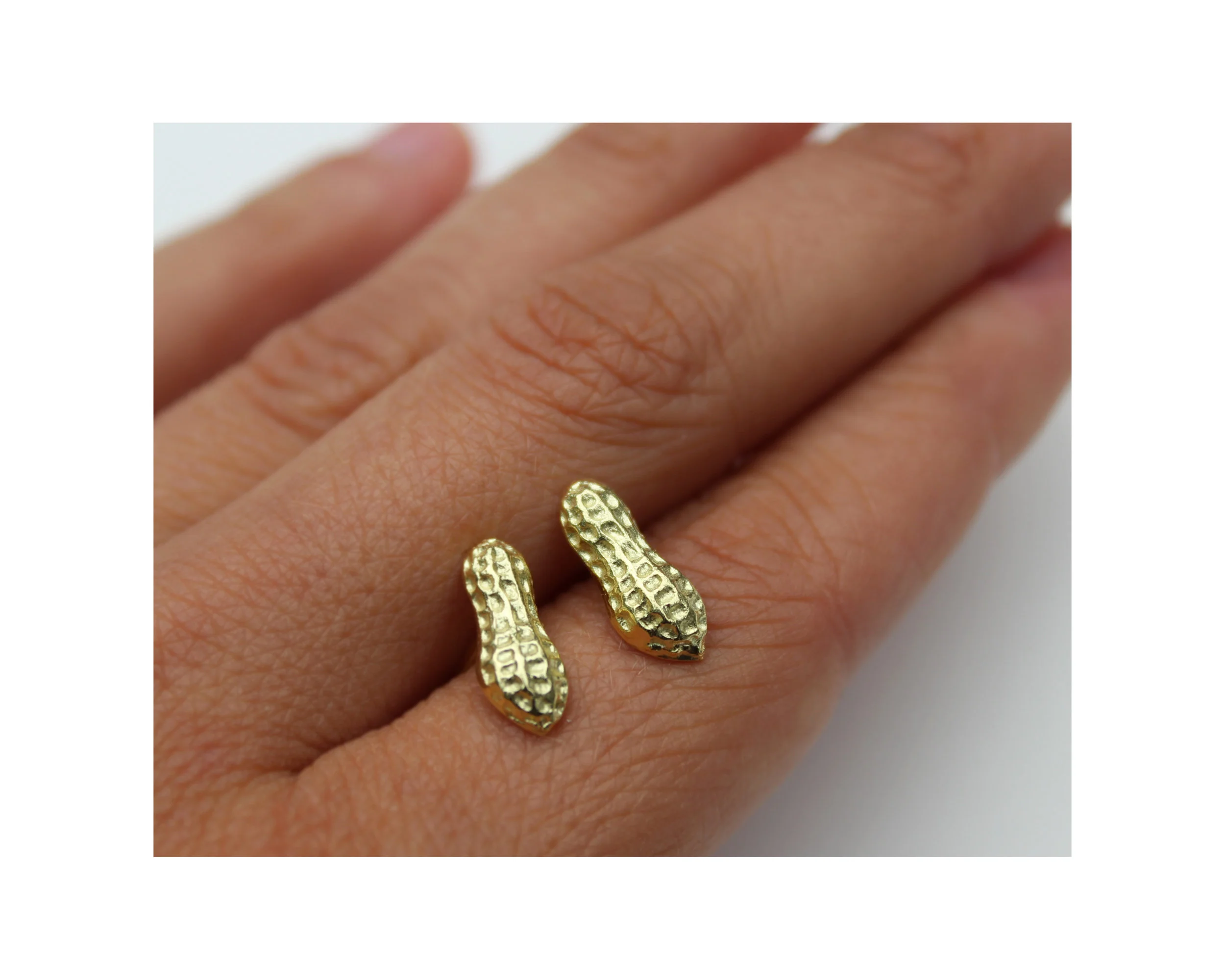 goldpeanutearringswhand.jpg