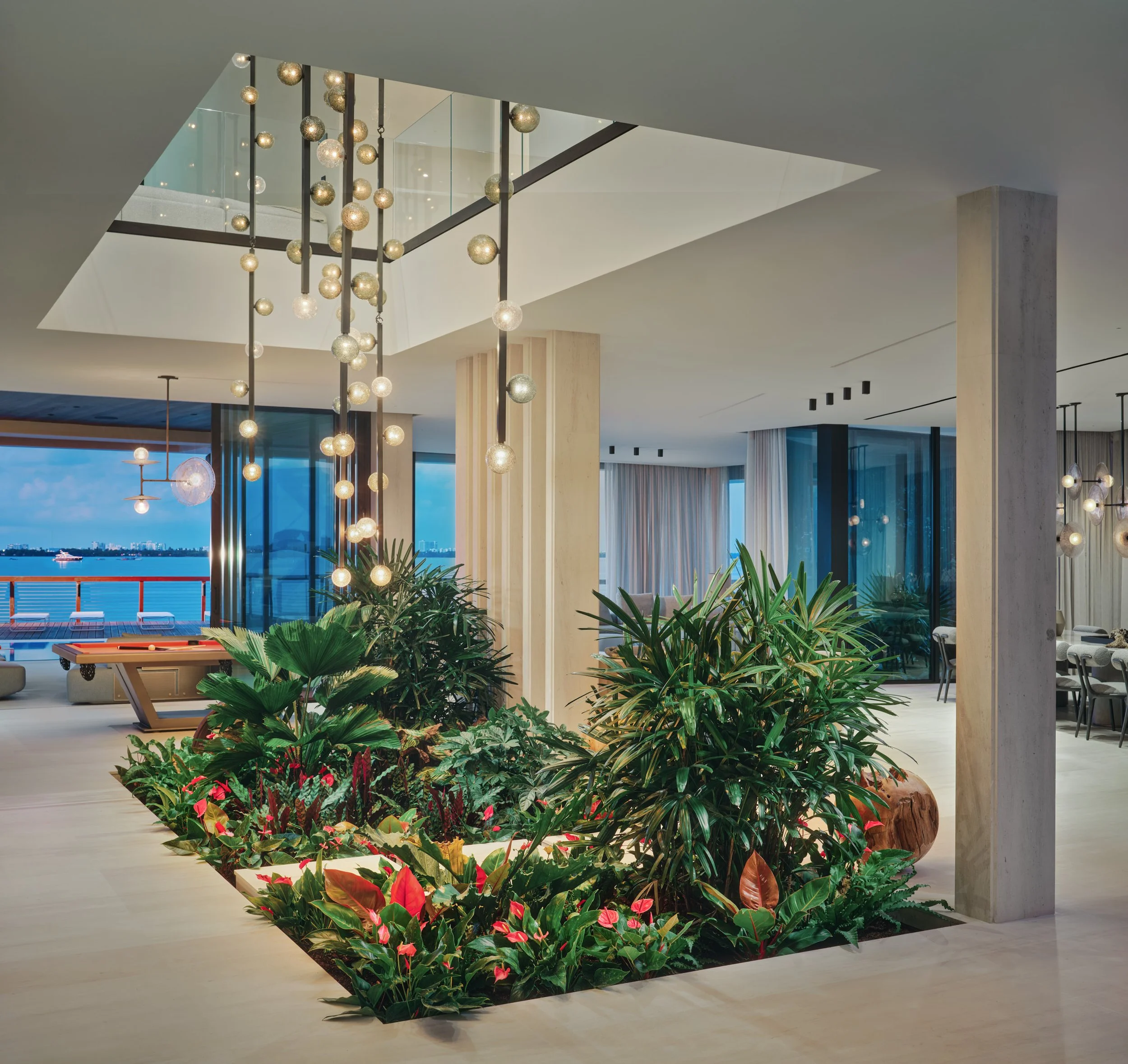 Architectural photograph of an interior tropical garden atrium inside a luxury waterfront residence on the Venetian Islands in Miami. Captured by Miami and Los Angeles-based architectural photographer Christian Santiago.