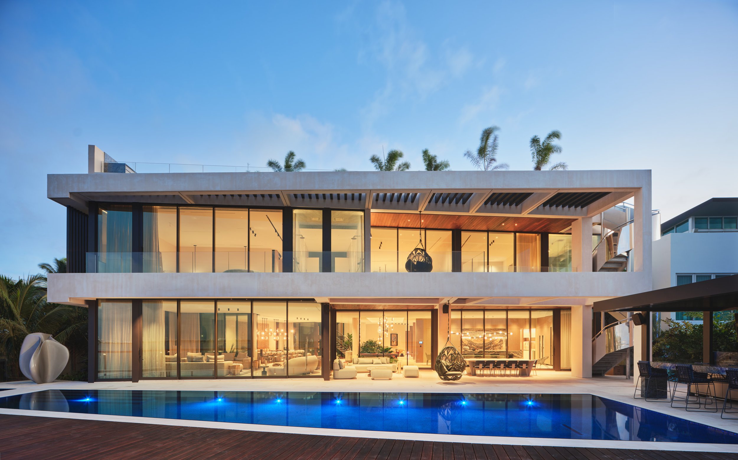 Architectural photograph of a modern luxury waterfront residence at twilight on the Venetian Islands in Miami. Captured by Miami and Los Angeles-based architectural photographer Christian Santiago