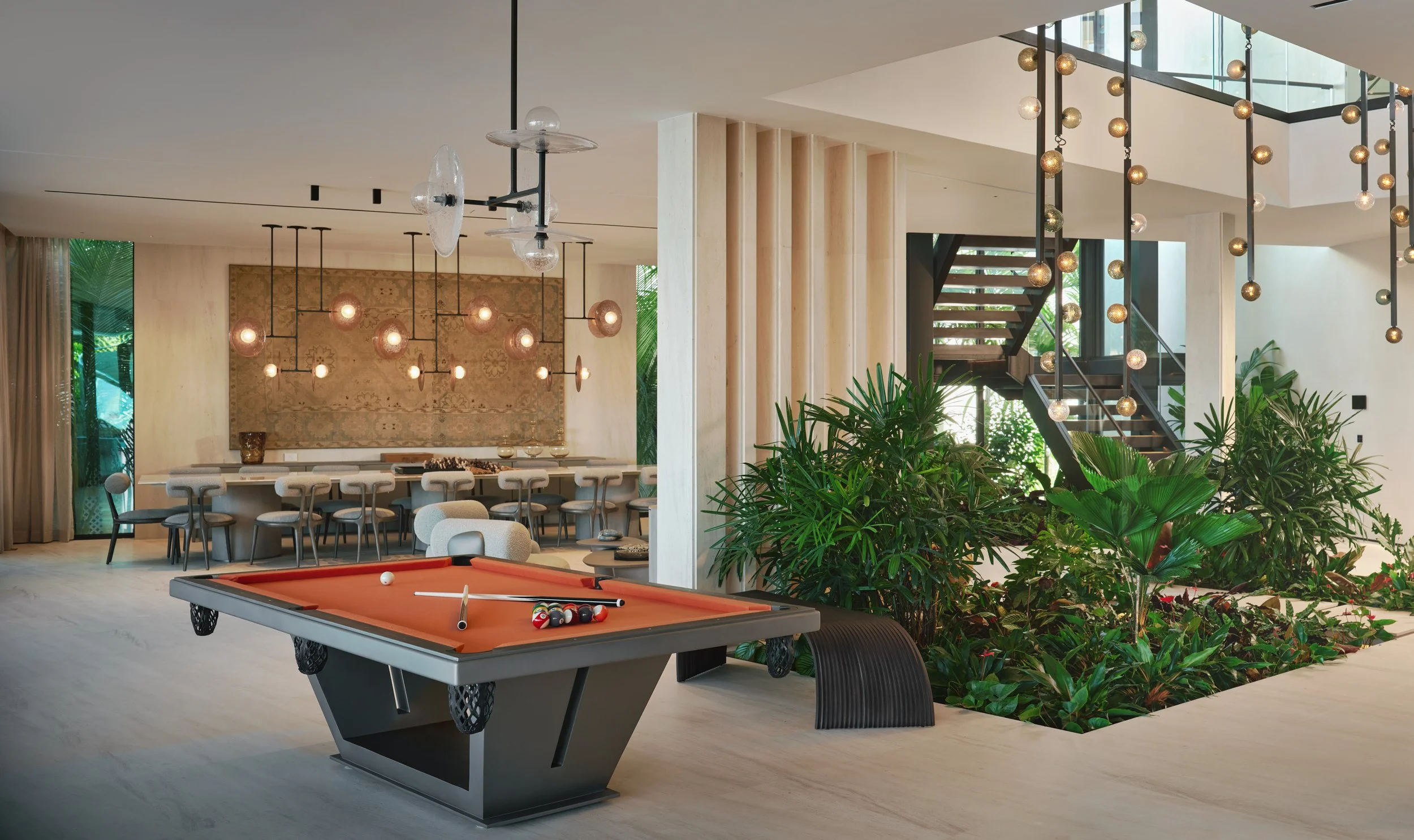 Architectural photograph of a luxury lounge with billiards table and interior garden inside a Venetian Islands waterfront residence in Miami. Captured by Miami and Los Angeles-based architectural photographer Christian Santiago.