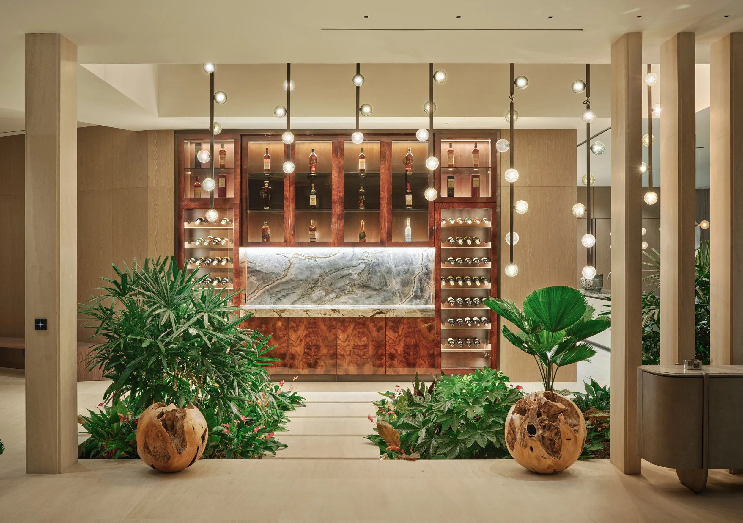Architectural photograph of a luxury wine bar and display wall inside a Venetian Islands waterfront residence in Miami. Captured by Miami and Los Angeles-based architectural photographer Christian Santiago.