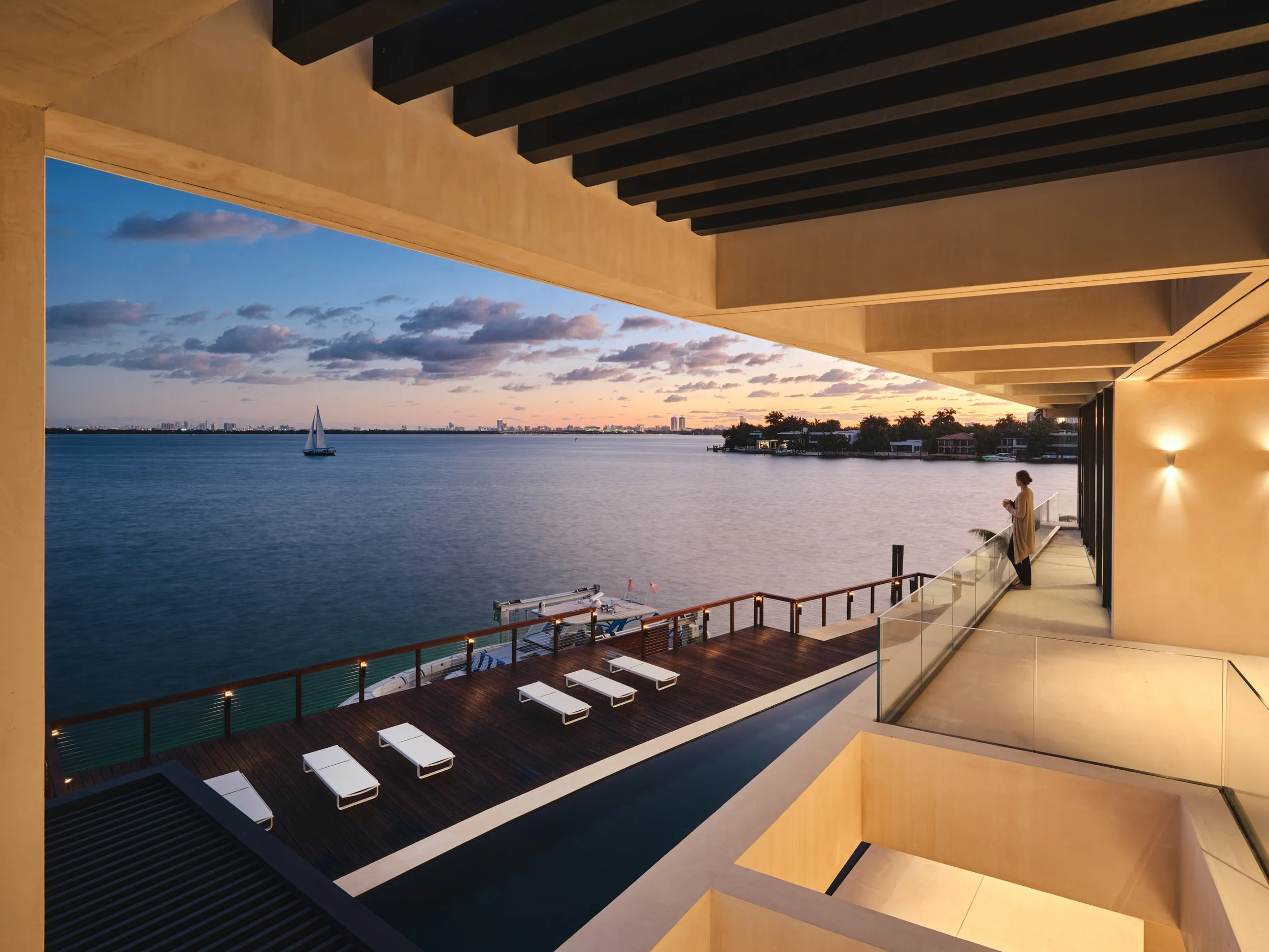 Architectural photograph of a modern waterfront balcony overlooking Biscayne Bay at sunset on the Venetian Islands in Miami. Captured by Miami and Los Angeles-based architectural photographer Christian Santiago.
