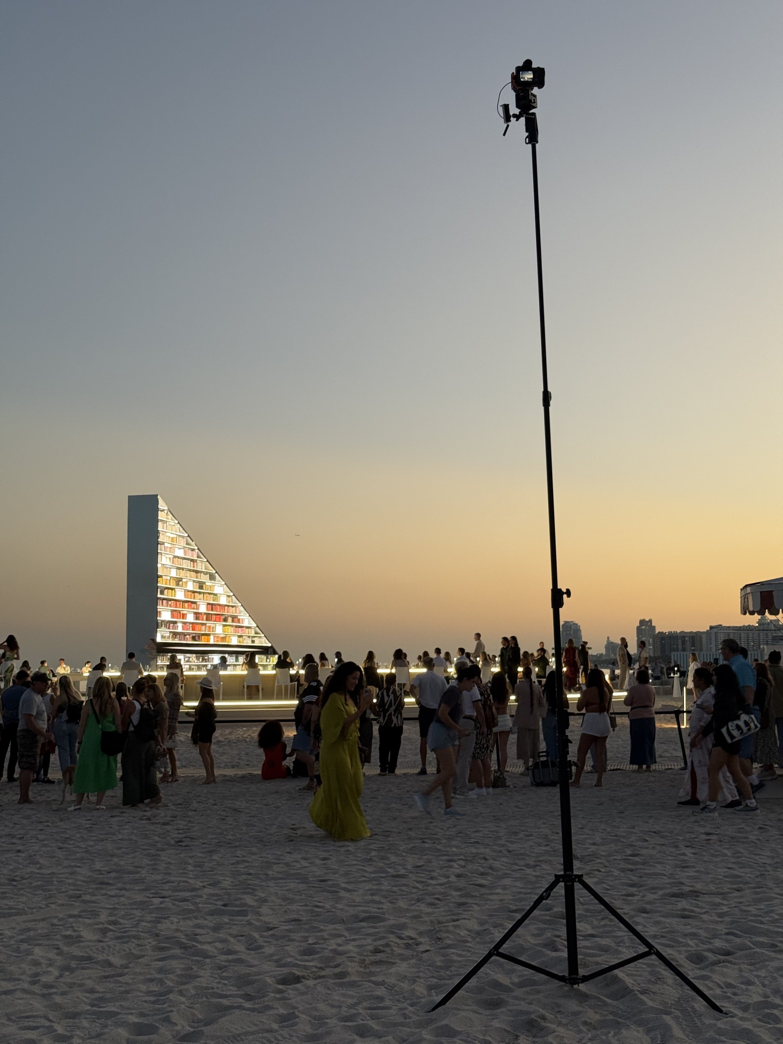 Architectural photograph of Es Devlin's Library of us public art installation at Faena Miami Beach during Art Basel, featuring a 25-foot tripod setup capturing the illuminated structure. Captured by Miami Architectural Photographer Christian Santiago