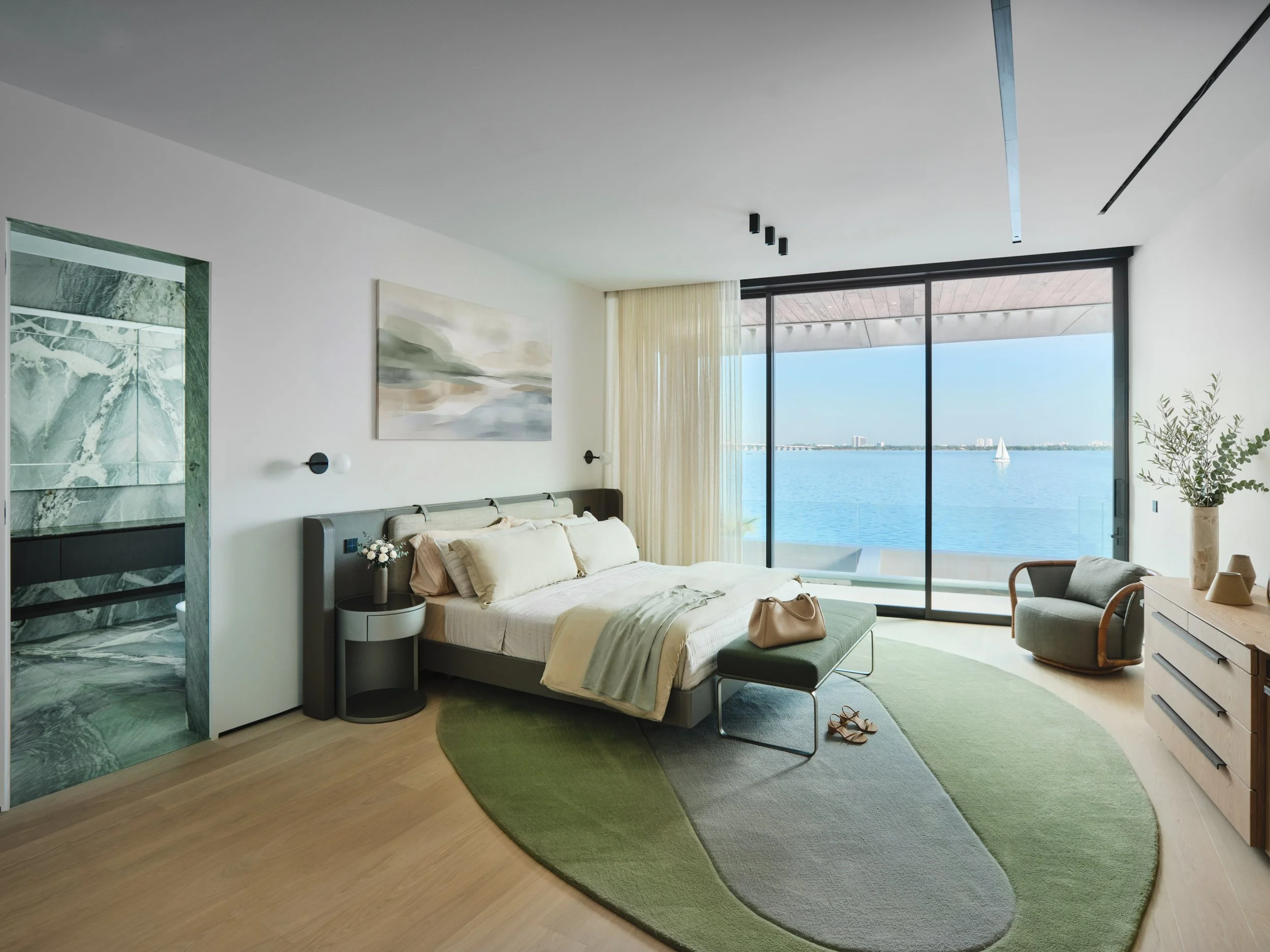 Architectural photograph of a luxury bedroom suite with floor-to-ceiling glass doors opening to Biscayne Bay views in a modern Venetian Islands waterfront residence in Miami. Captured by Miami and Los Angeles-based architectural and travel photograph