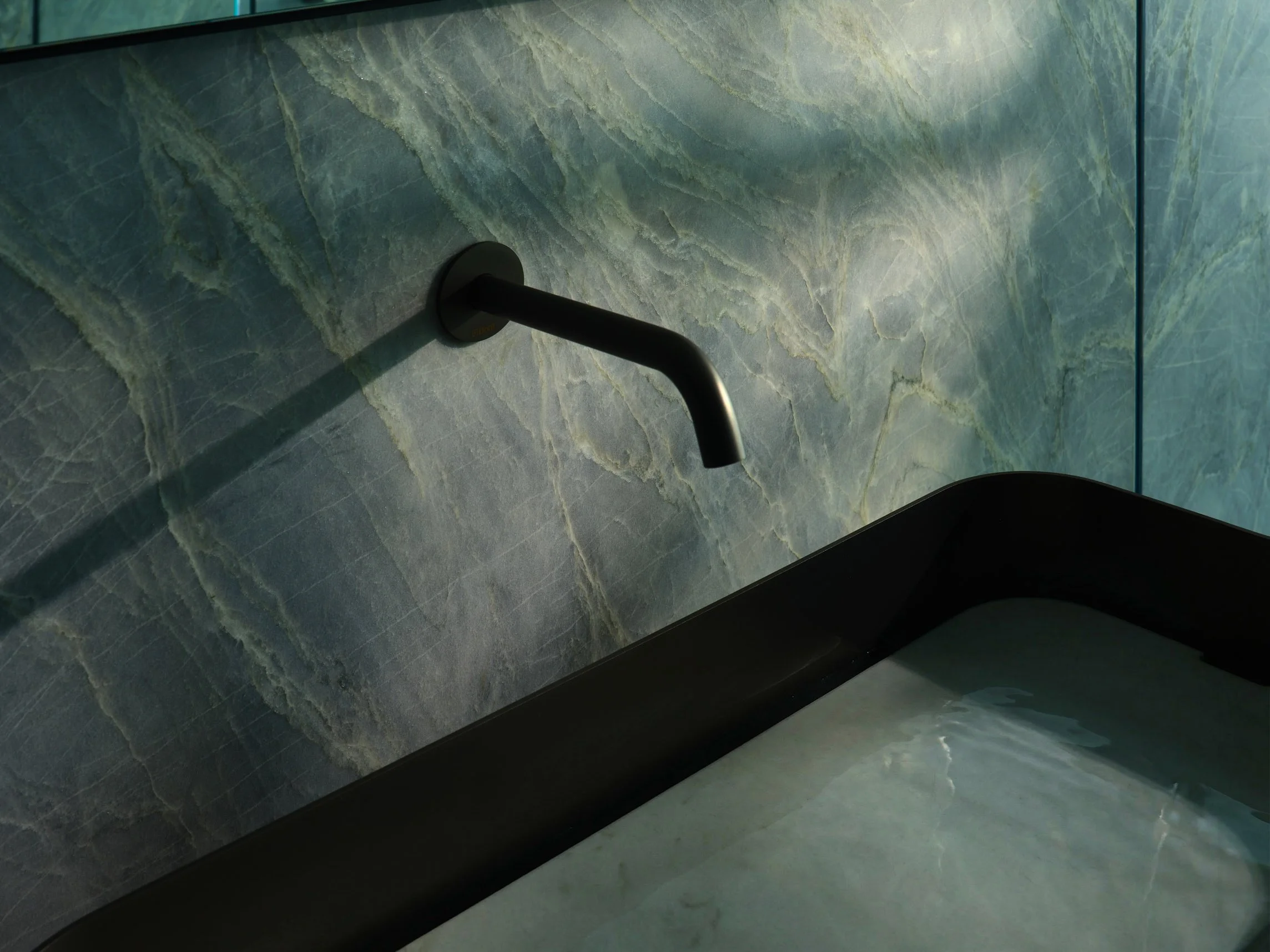 Architectural photograph of a modern residential atrium with sculptural globe chandelier, indoor tropical garden, and floating staircase in a luxury Miami home. Captured by Miami and Los Angeles-based architectural and travel photographer Christian S