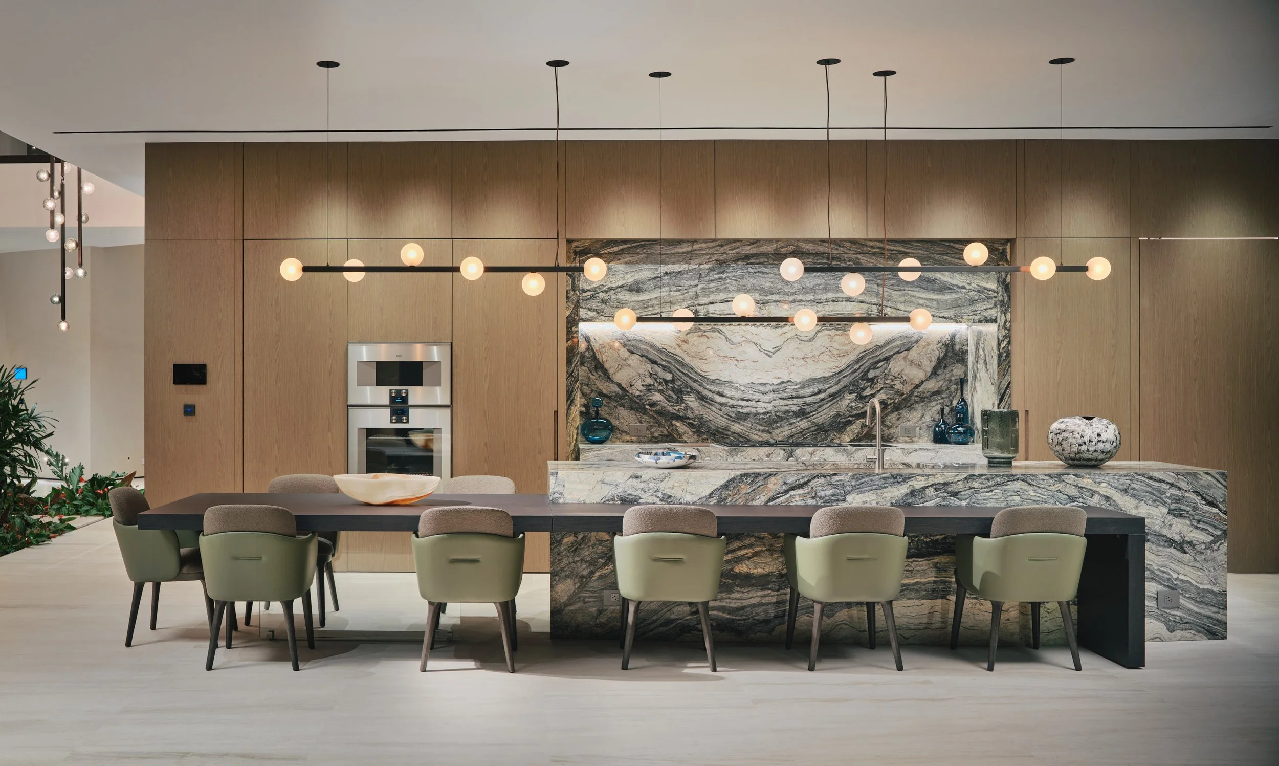 Architectural photograph of a luxury kitchen with marble island and custom wood cabinetry inside a Venetian Islands waterfront residence in Miami. Captured by Miami and Los Angeles-based architectural photographer Christian Santiago.