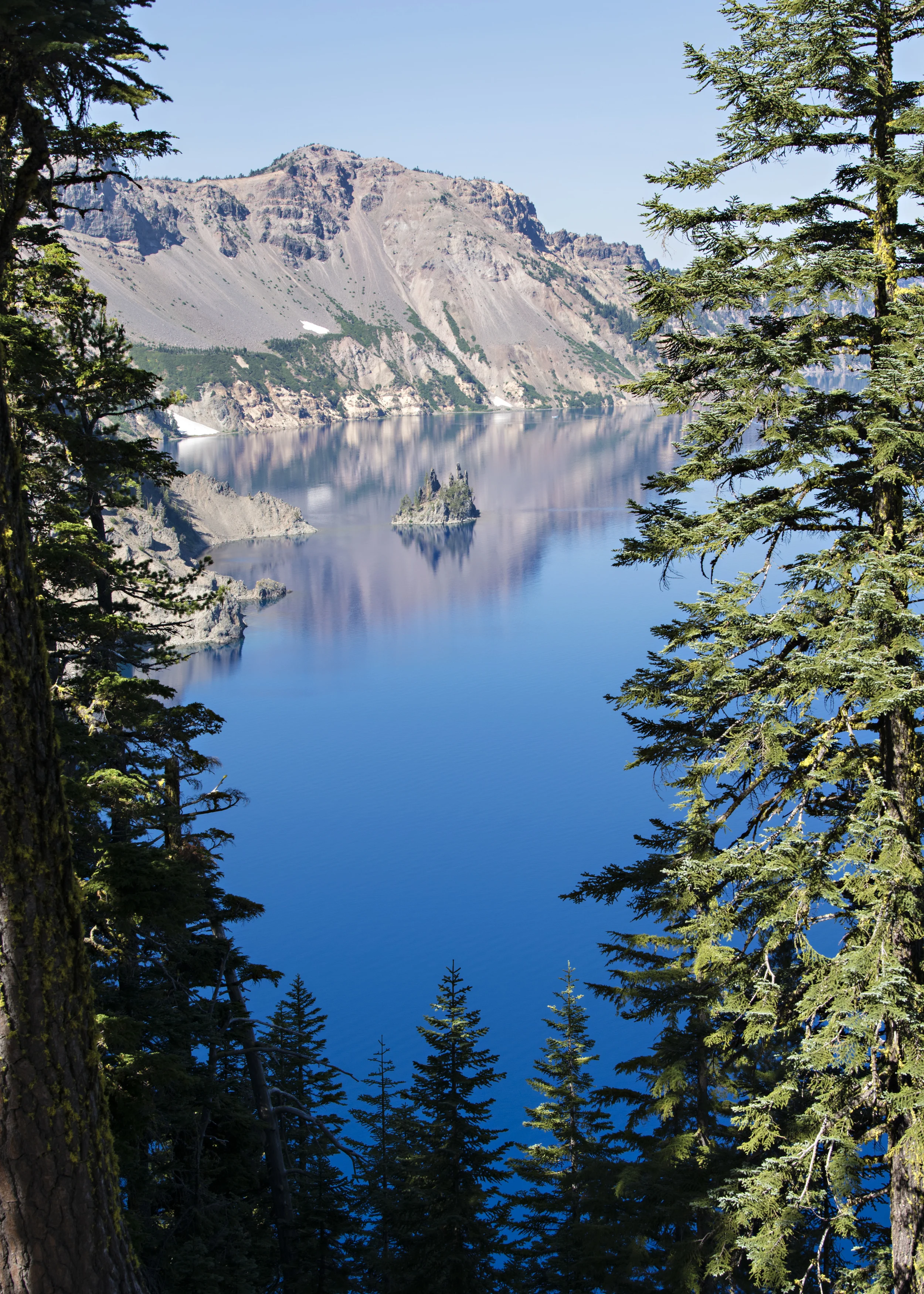 Crater Lake is impossibly blue. This is a view through the trees to Phantom Shiprock. Nikon D800, Nikkor 24-120mm @ 38mm, ISO 100, f8, 1/100 sec. 