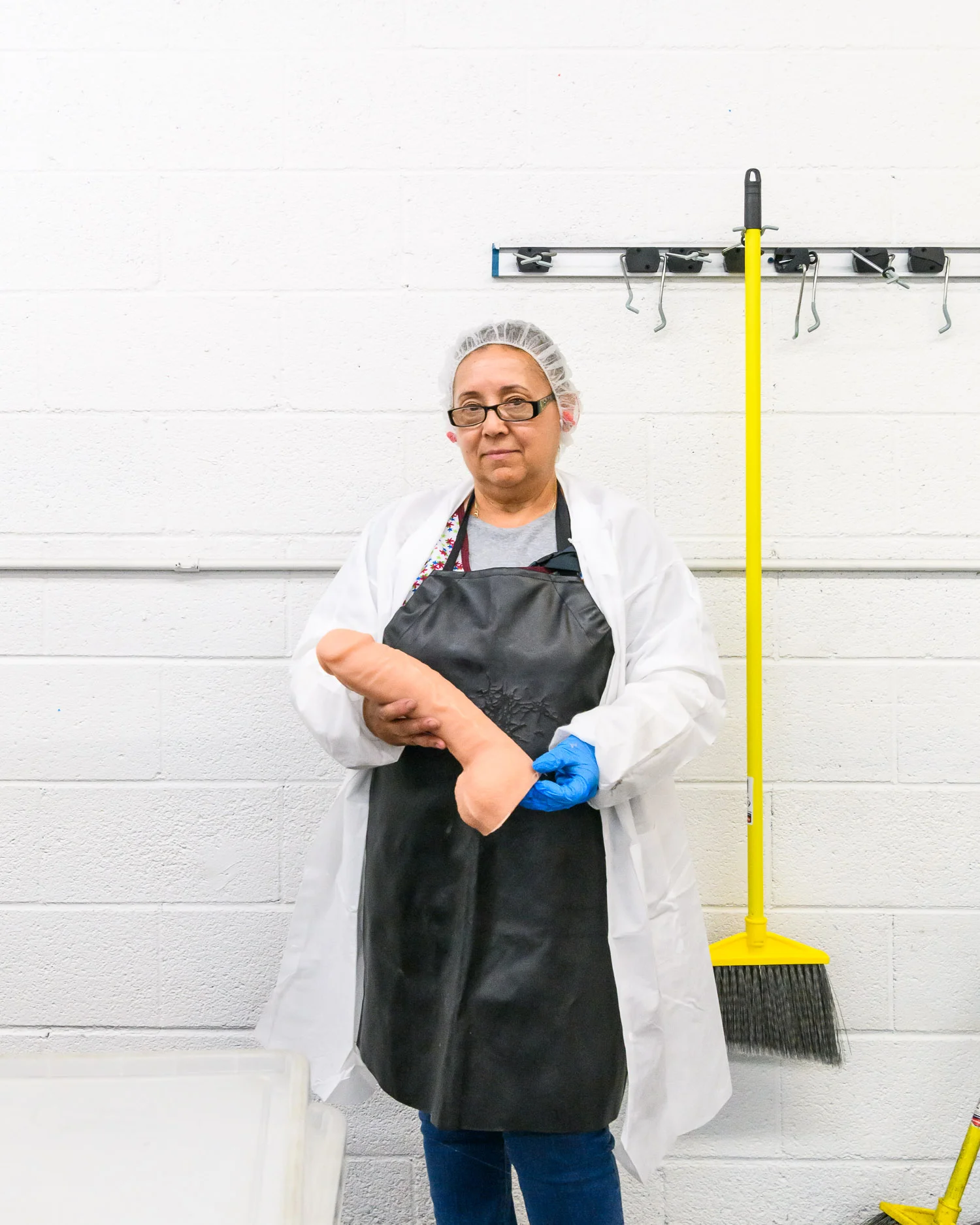 An employee with a freshly moulded Doc Johnson dildo, at the factory in Los Angeles.