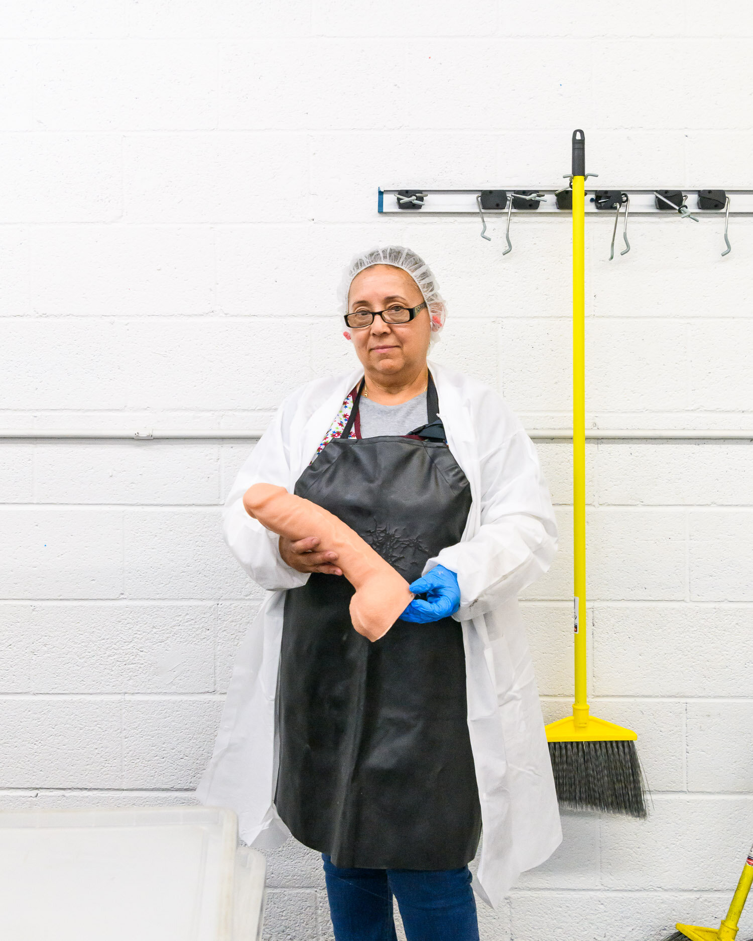  An employee with a freshly moulded Doc Johnson dildo, at the factory in Los Angeles.     Doc Johnson is the largest US manufacturer of adult pleasure products, with 450 employees producing 75,000 products per week in their Los Angeles factory. "The 