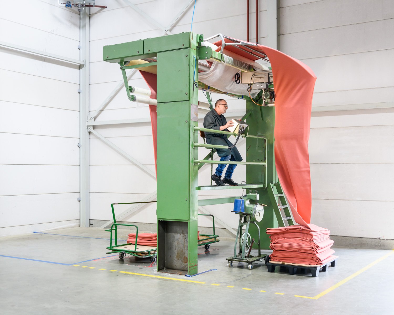 Knitted textile being cut at Innofa textile mill, Kvadrat Febrik, Netherlands, 2019