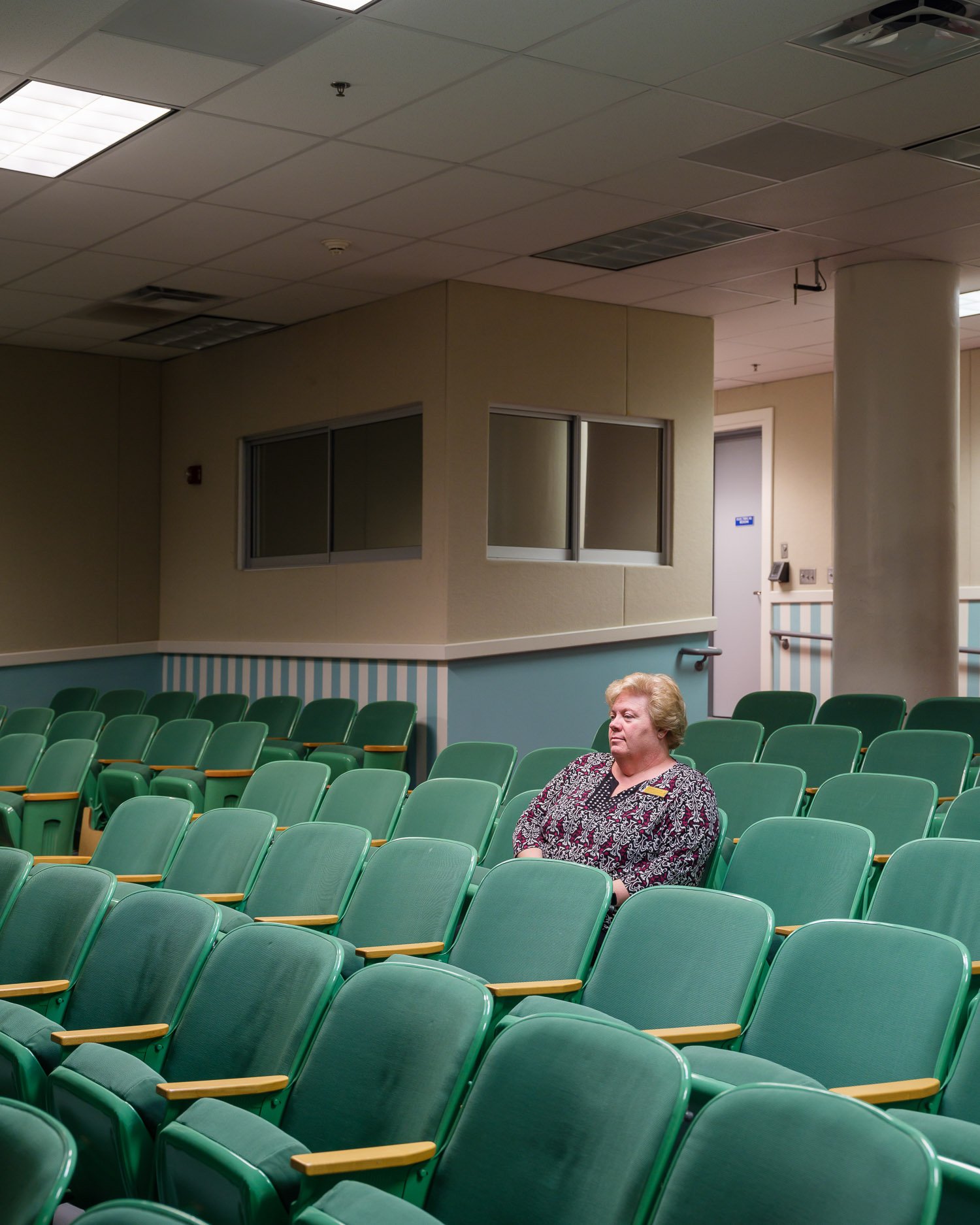  Deanna Hylton, a guide at the bunker, sitting in the Governor's Hall, built to hold the House of Representatives in the event of a nuclear attack. The hotel used this hall to hold conferences during peaceful times, with those partaking having no ide