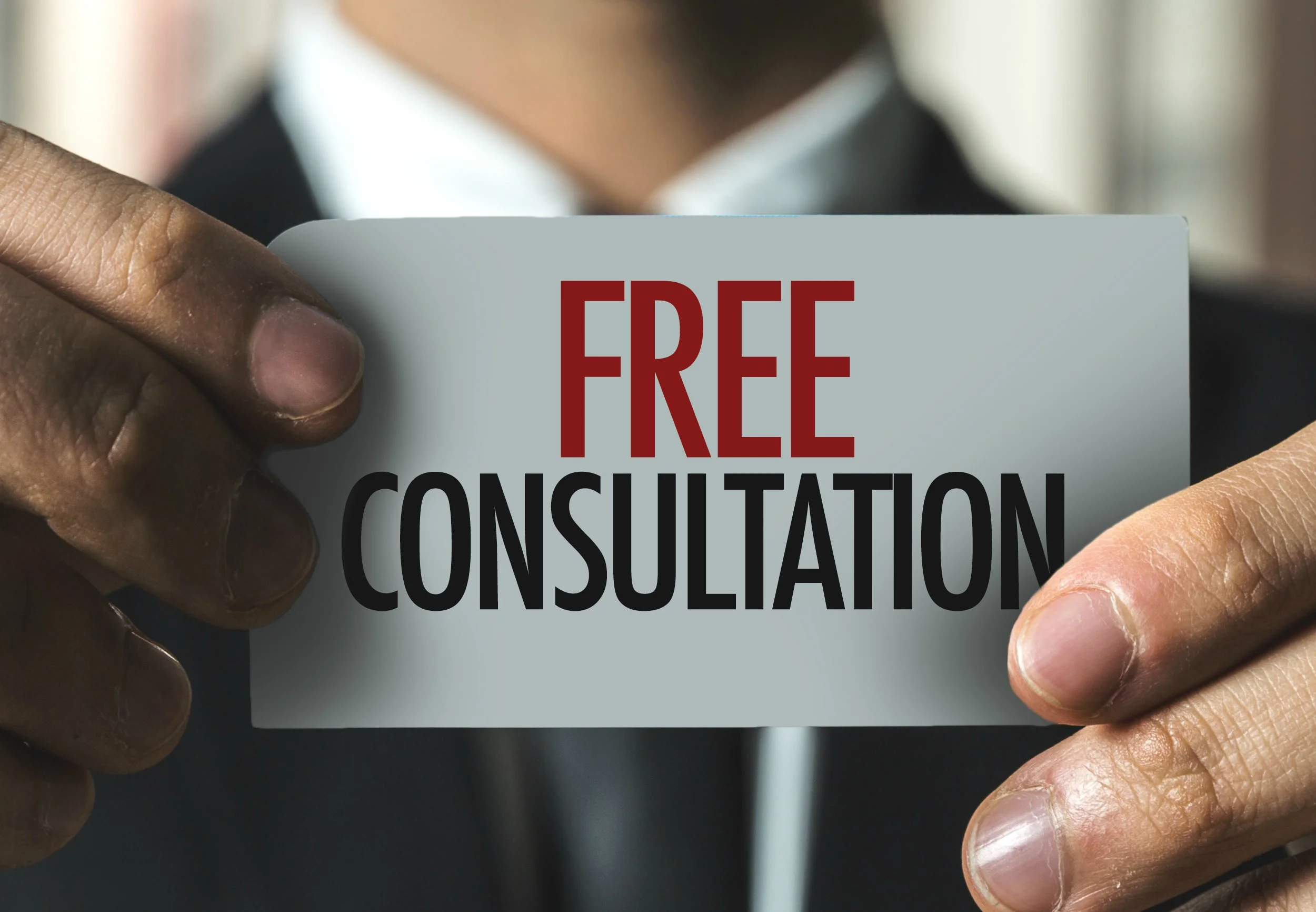 Man holding up a card saying free consultation