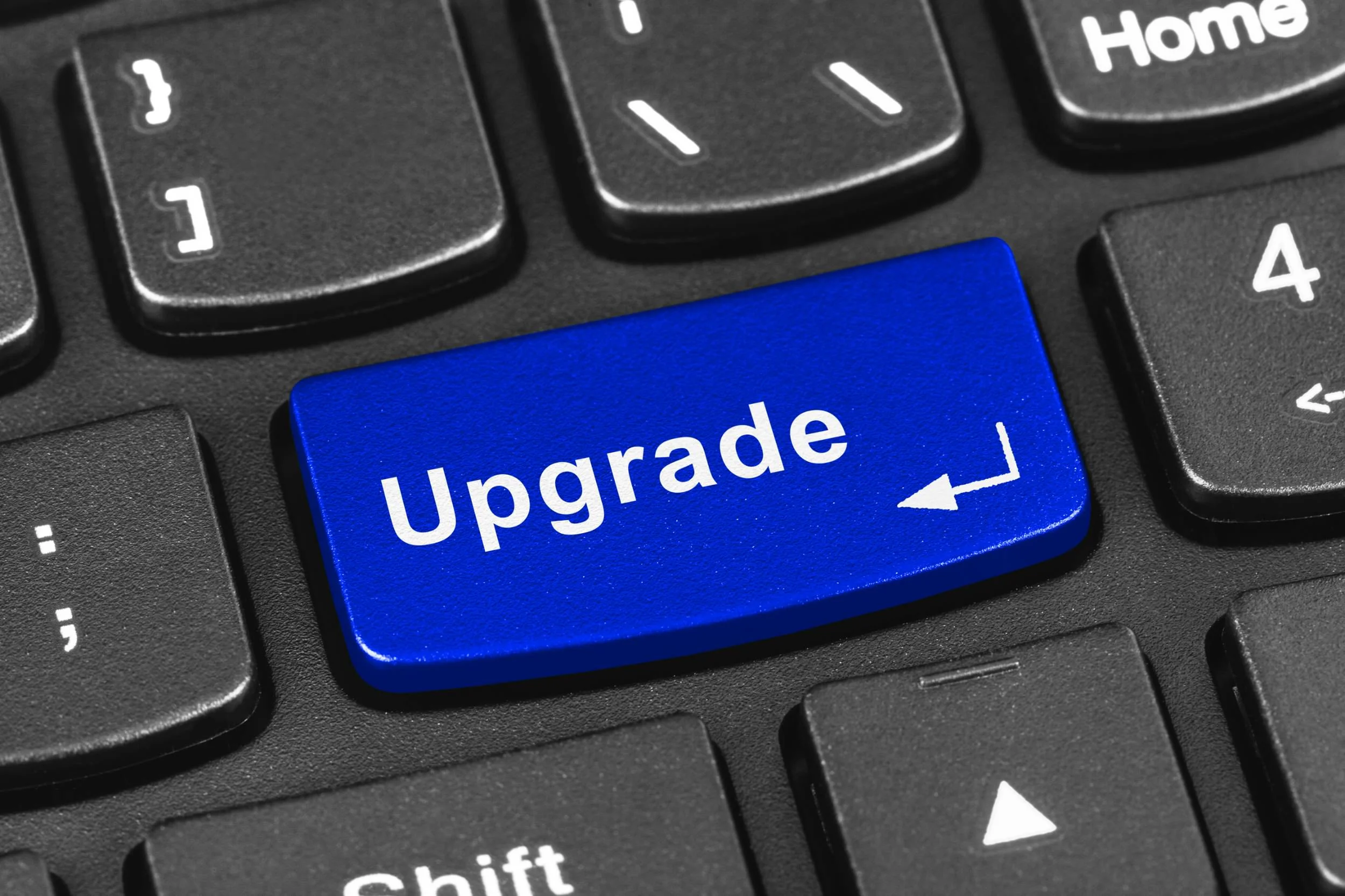 Keyboard with blue key that says upgrade
