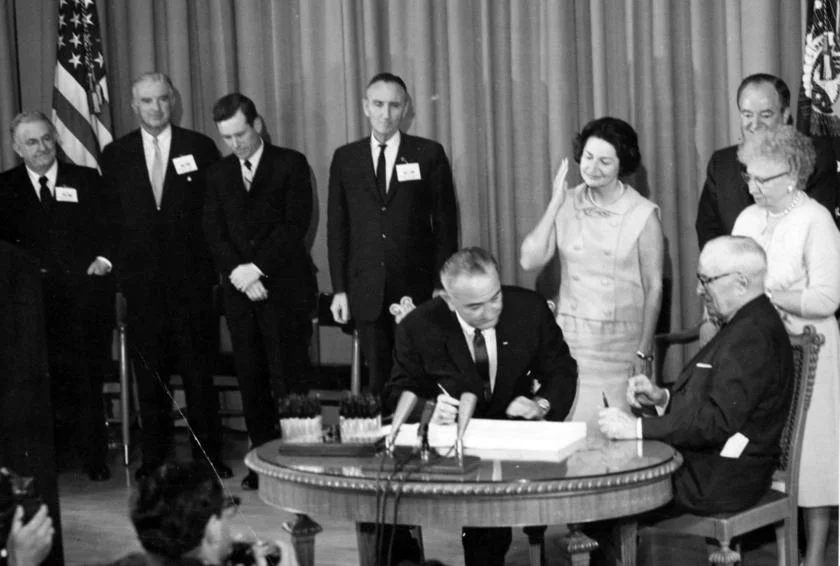 President Lyndon B. Johnson signs the Medicare bill at the Harry S. Truman library in 1965. Source: Truman Library