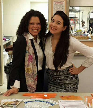 Spring and Frania at an outreach event for families providing information about healthcare.