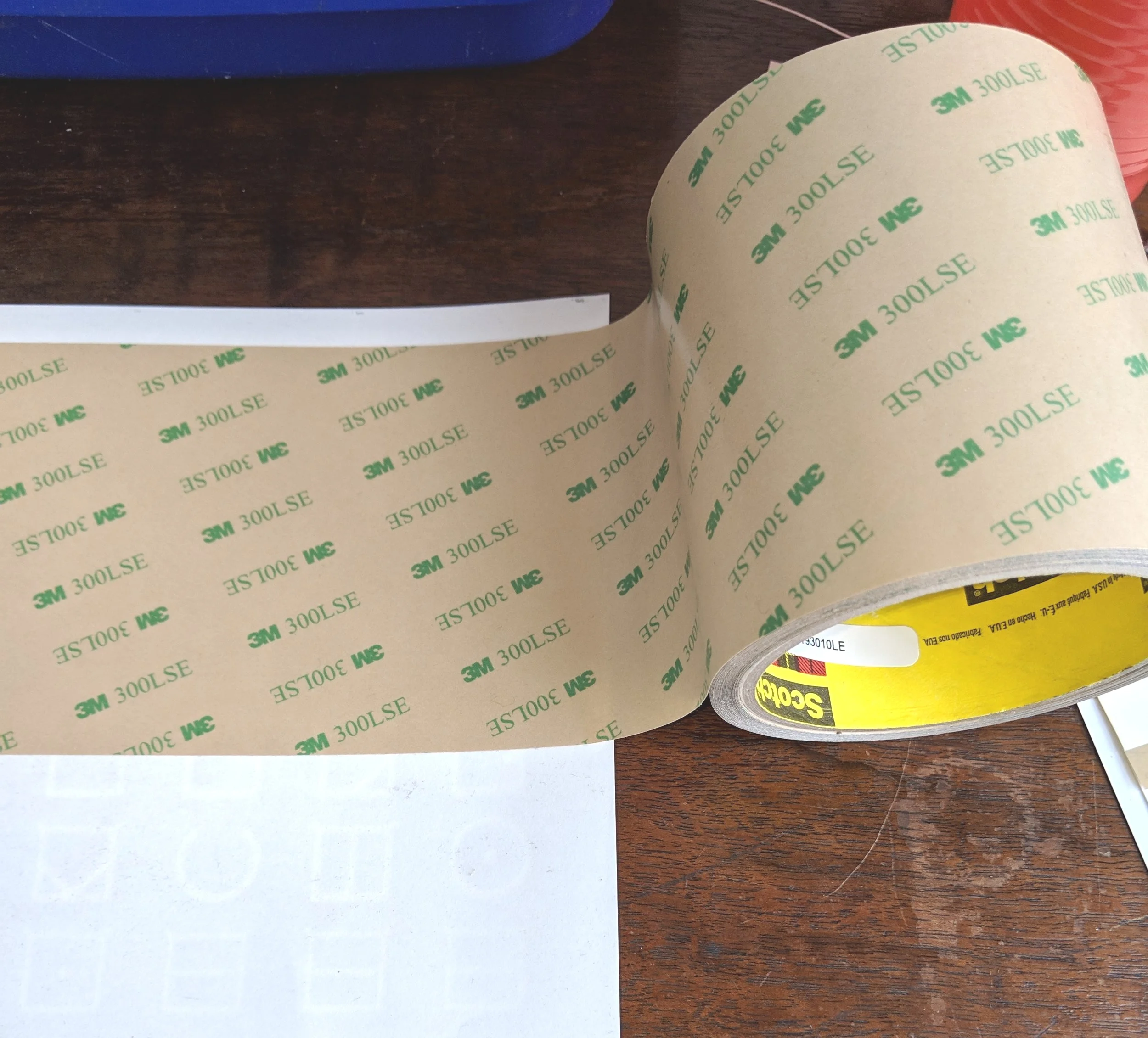 3M adhesive transfer being applied to ELIA Frame adhesive and hanging label prototypes.