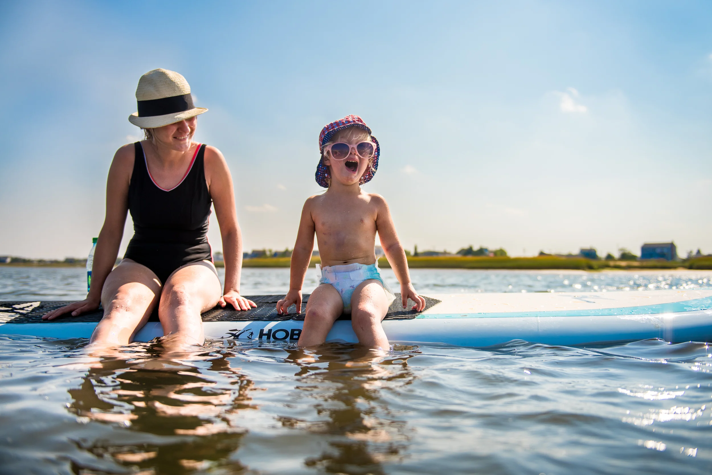 Molly Rees Photo - Documentary Childhood Photography - girl crying on paddleboard on Plum Island in Newburyport, Massachusetts by M. Menschel