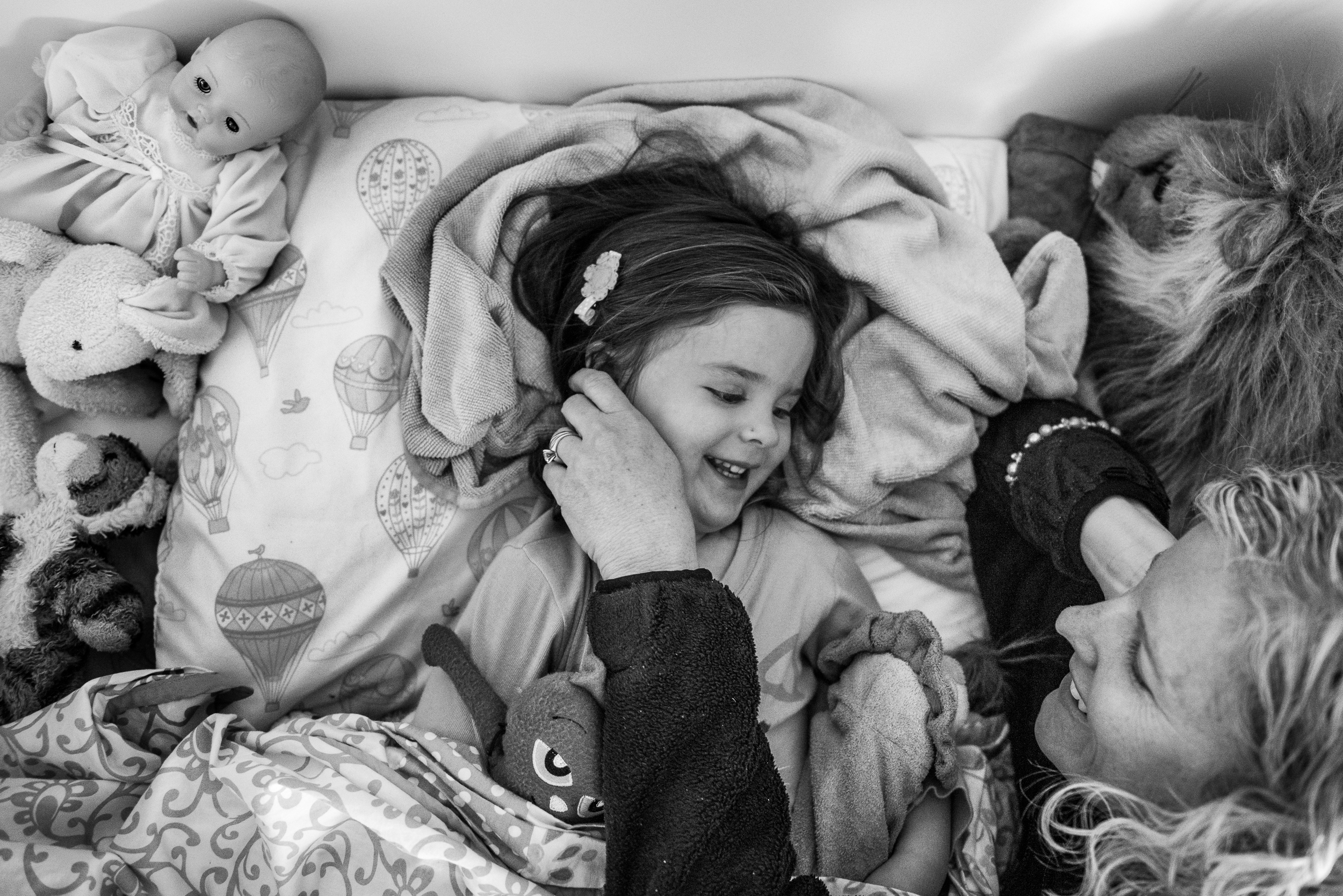 Molly Rees Photo - Black and White Documentary Family Photography - mother putting daughter to bed M. Menschel