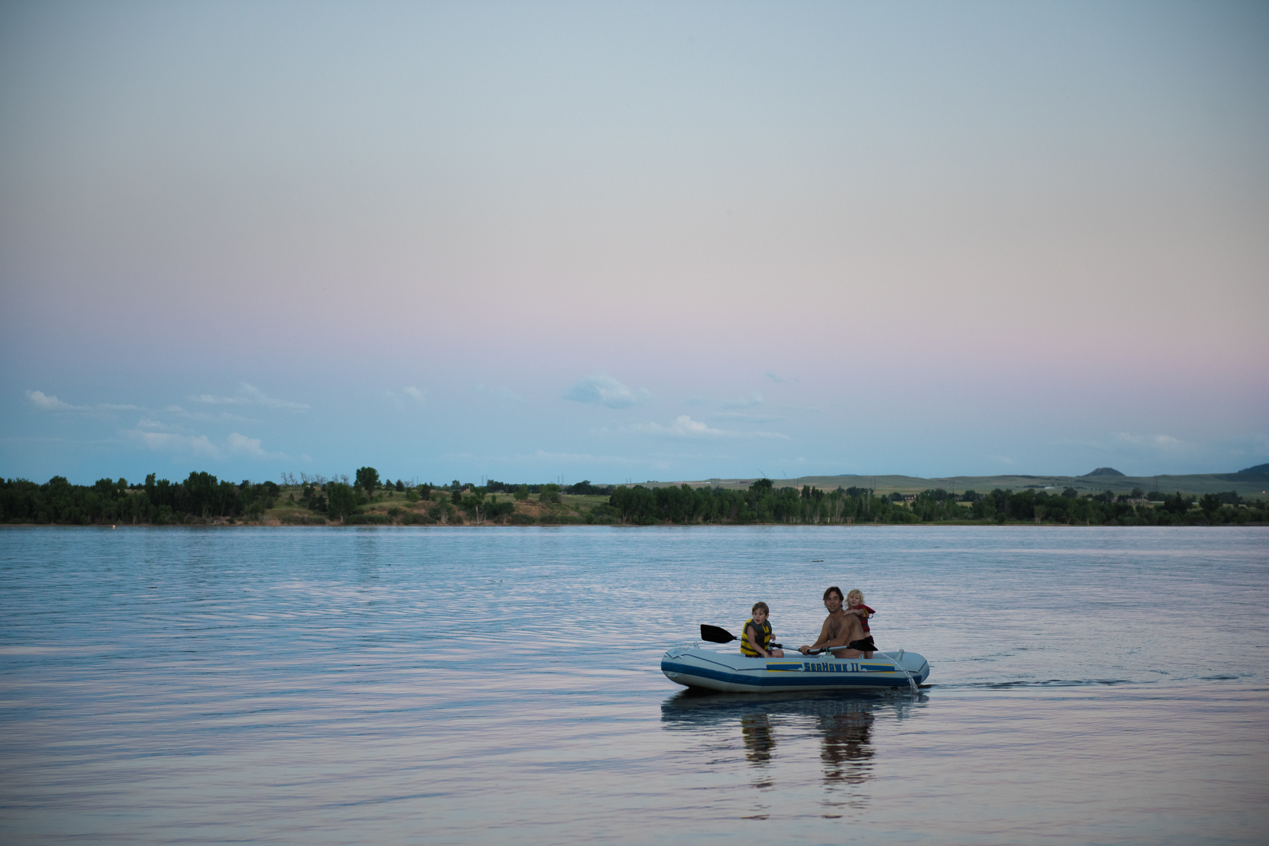 Blog - The Pen & Camera - Molly Rees Photo - Documentary Childhood Photography - children in raft at sunset at Chatfield Reservoir in Denver, Colorado by M. Menschel