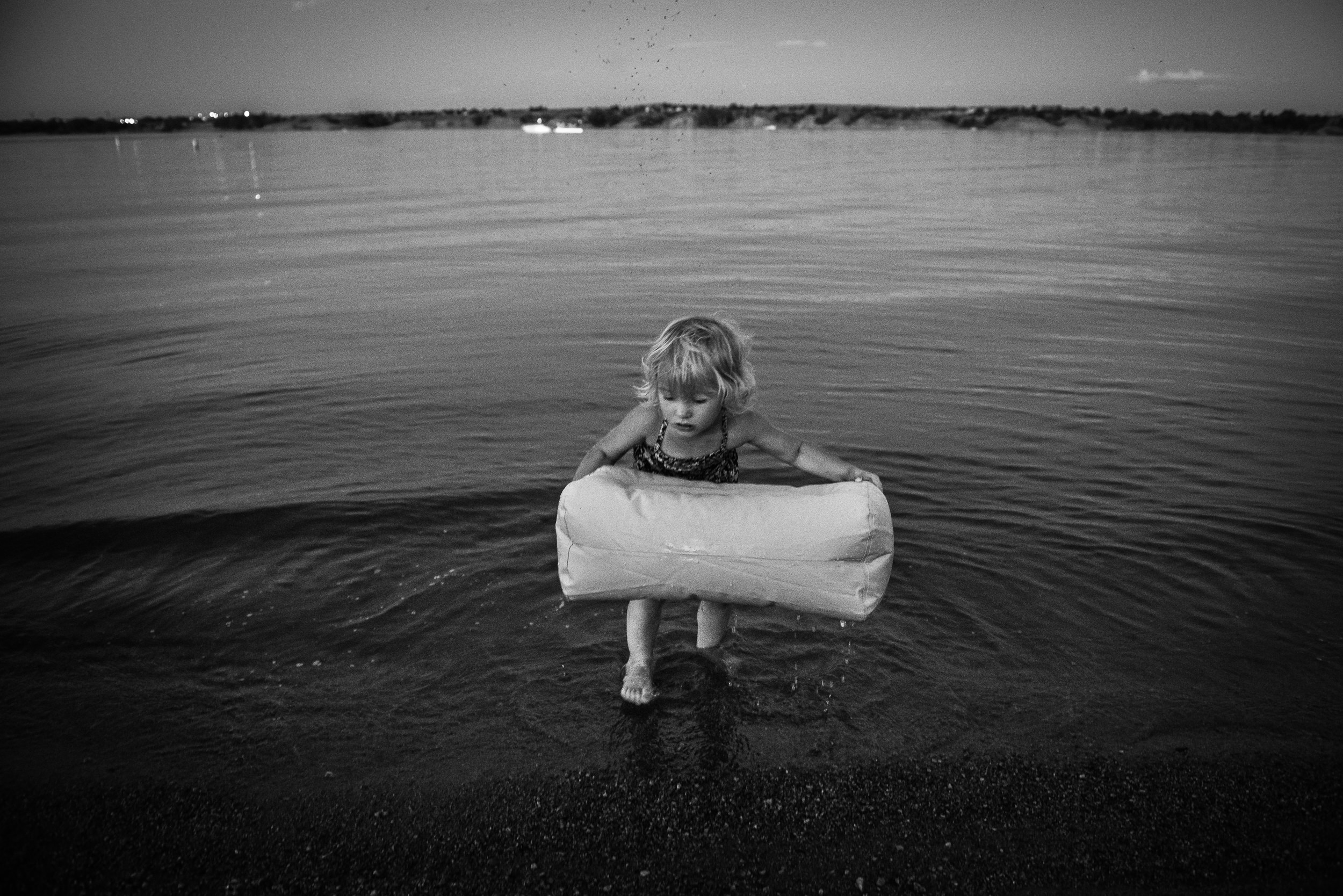 Blog - The Pen & Camera - Molly Rees Photo - Black and White Documentary Childhood Photography - girl at night in water at Chatfield Reservoir in Denver, Colorado by M. Menschel