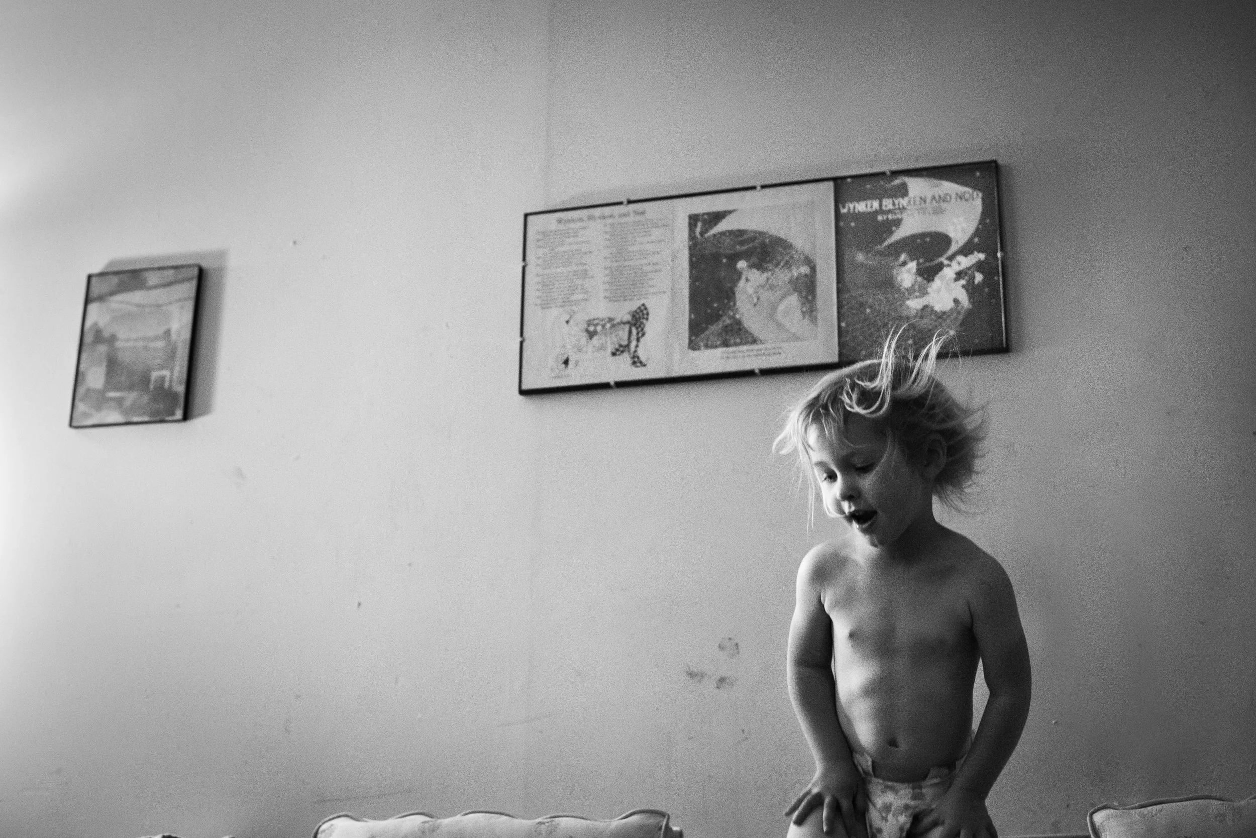 Blog - The Pen & Camera - Inspirational, Poetry, Spirituality, Writing, Denver, Colorado - Molly Rees Photo - Black and White Documentary Childhood Photography - girl jumping on couch by M. Menschel "On Children," poem by Khalil Gibran