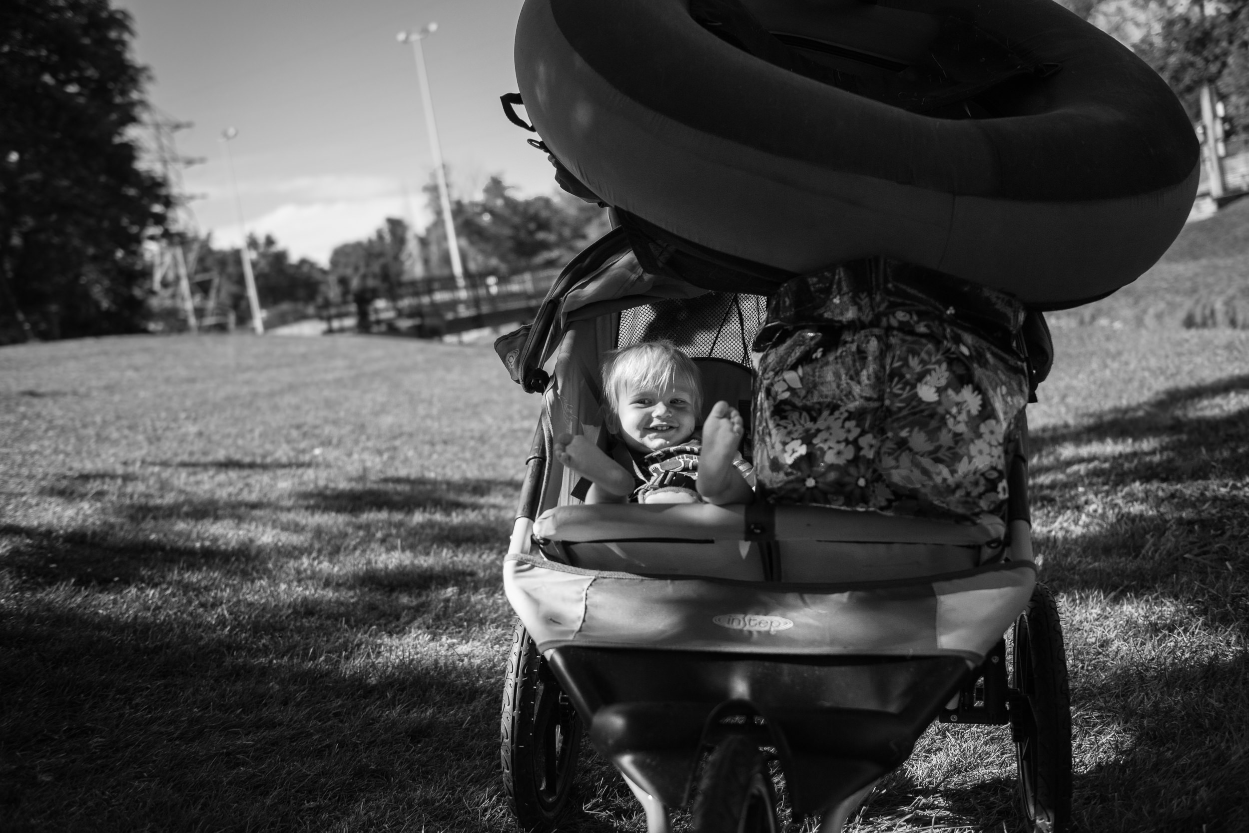 Blog - The Pen & Camera - Molly Rees Photo - Black and White Documentary Childhood Photography - boy in stroller with tube at Belleview Park in Denver, Colorado by M. Menschel