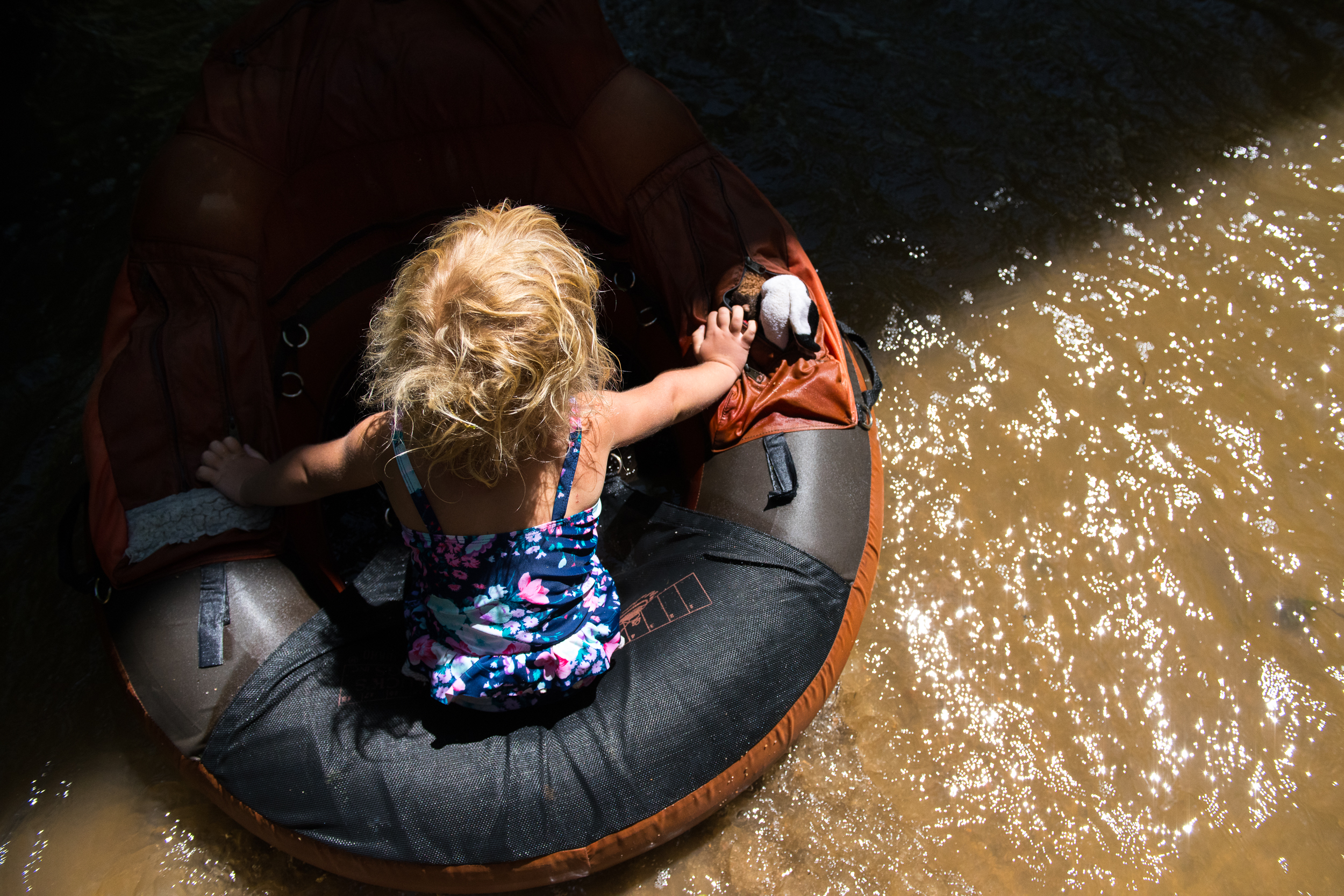 Blog - The Pen & Camera - Molly Rees Photo - Documentary Childhood Photography - children tubing in stream through woods at Belleview Park in Denver, Colorado by M. Menschel